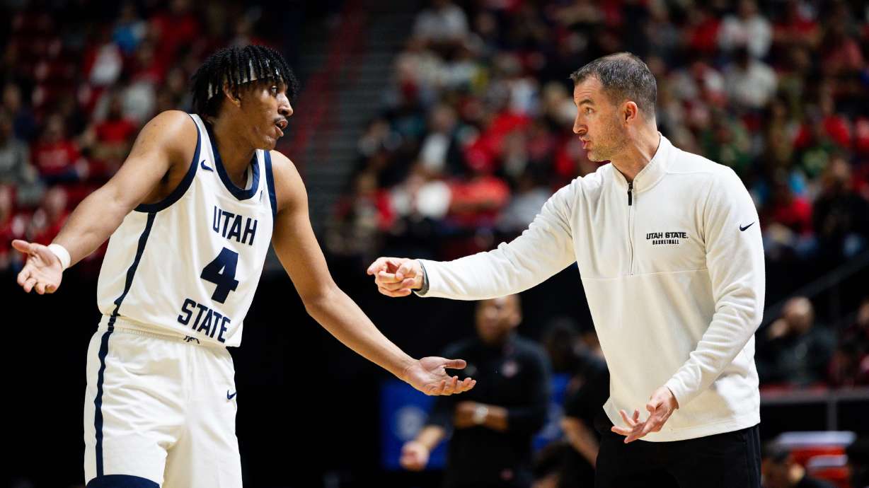 Utah State Aggies head coach Danny Sprinkle talks to Utah State Aggies guard Ian Martinez (4) during the game between the Utah State Aggies and the San Diego State Aztecs in the semifinals of the Mountain West 2024 Men's Basketball Championship at the Thomas & Mack Center in Las Vegas on Friday, March 15, 2024.