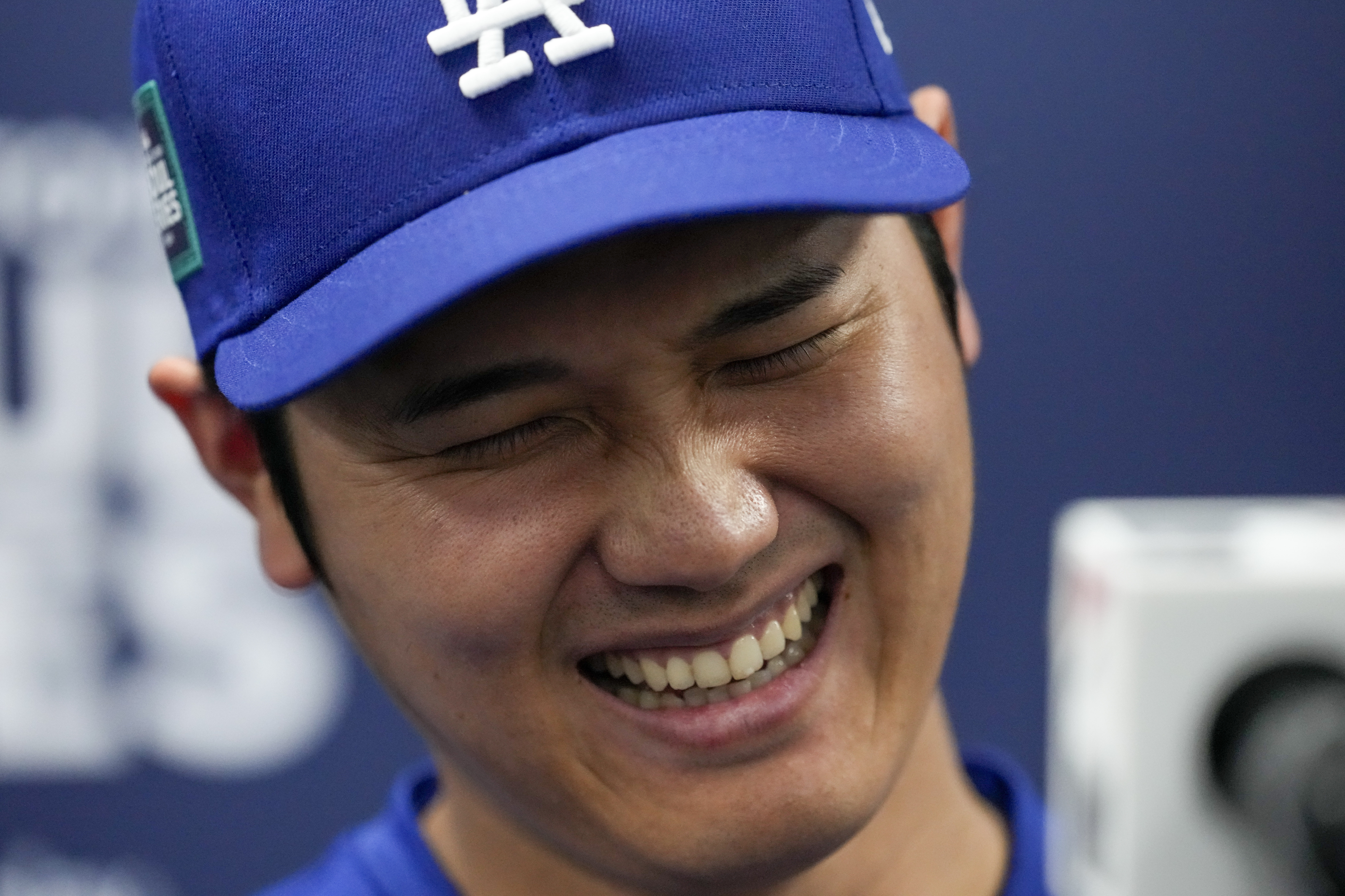 Los Angeles Dodgers' Shohei Ohtani reacts during a news conference ahead of a baseball workout at the Gocheok Sky Dome in Seoul, South Korea, Saturday, March 16, 2024. 