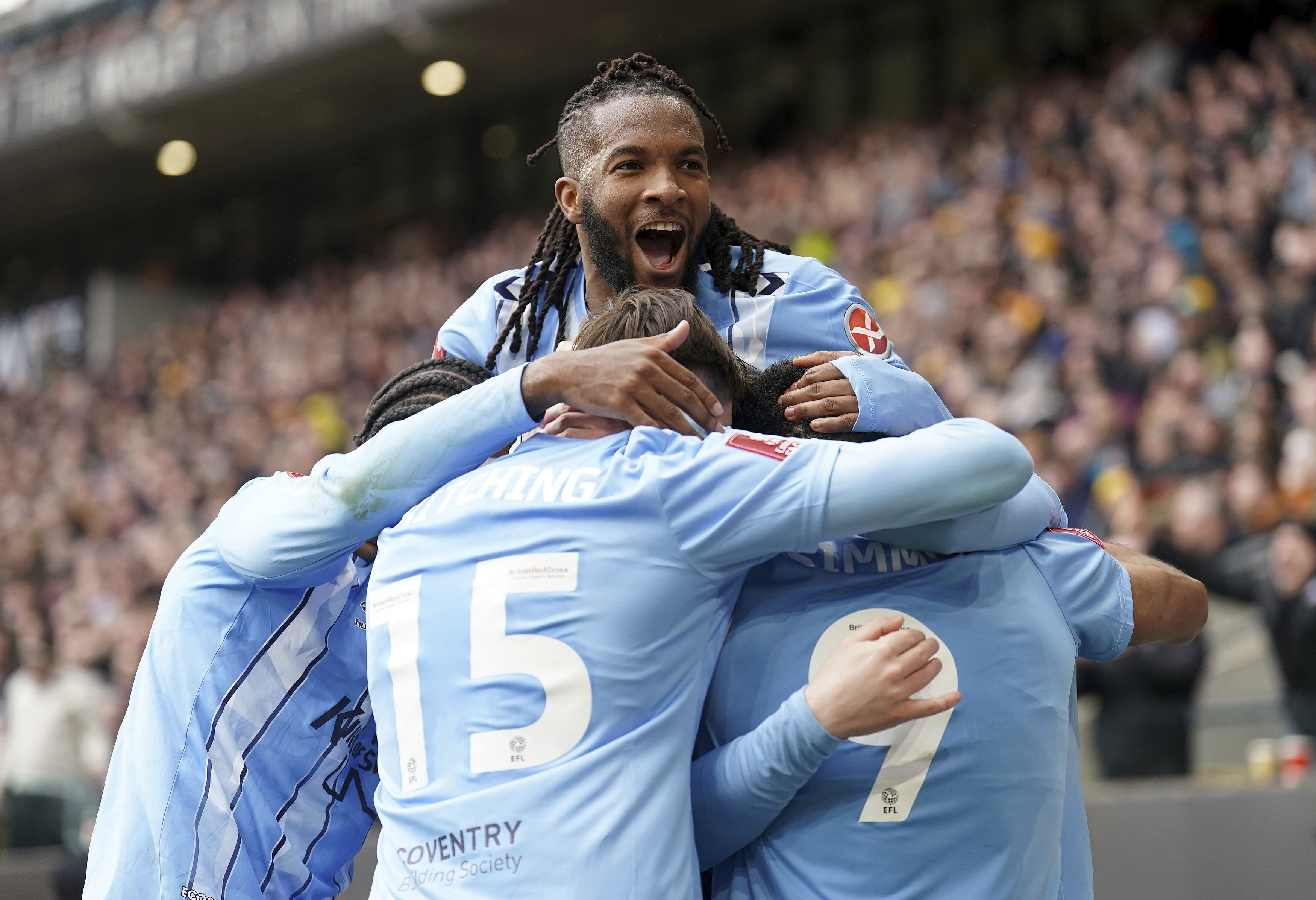 Coventry City's Kasey Palmer celebrates with teammates after Ellis Simms scored his side's first goal, during the English FA Cup quarter final match soccer match between Wolverhampton and Coventry City, at the Molineux, Wolverhampton, England, Saturday, March 16, 2024. 