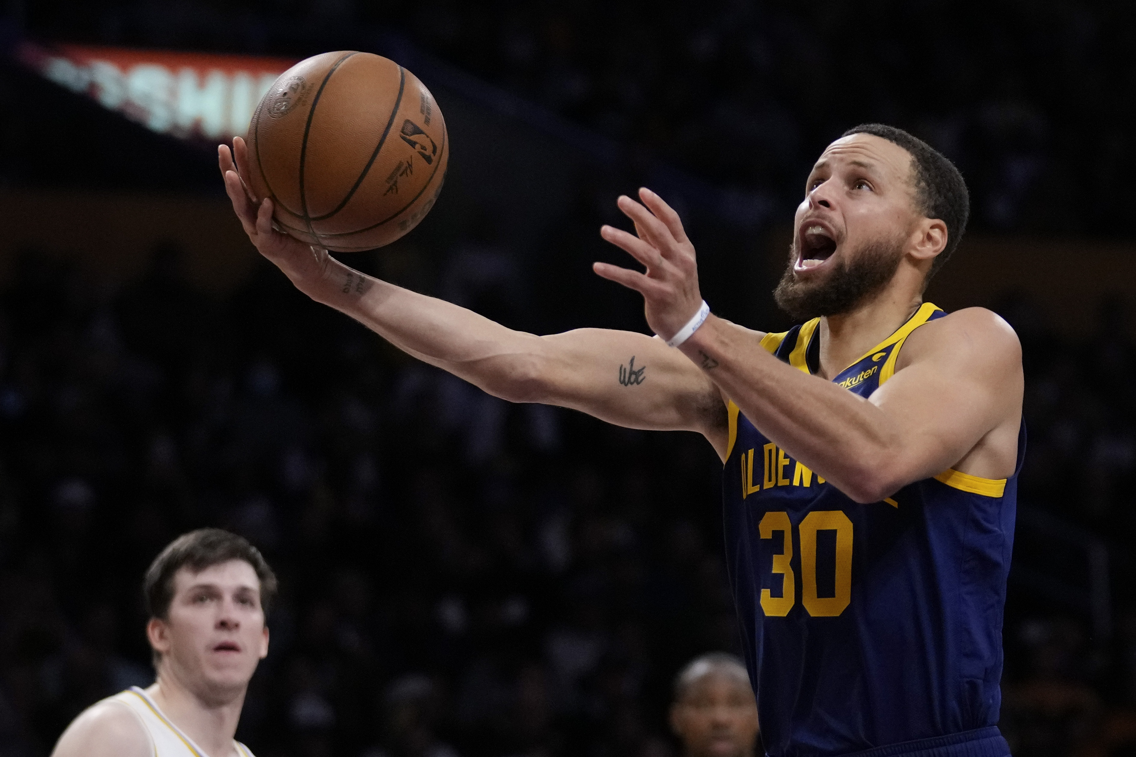 Golden State Warriors guard Stephen Curry (30) shoots during the first half of an NBA basketball game against the Los Angeles Lakers in Los Angeles, Saturday, March 16, 2024. 