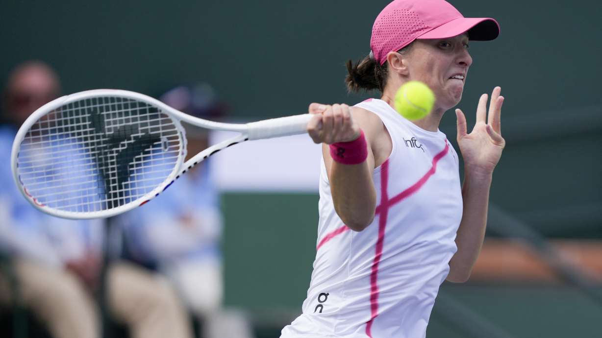Iga Swiatek, of Poland, returns to Maria Sakkari, of Greece, during the final match at the BNP Paribas Open tennis tournament, Sunday, March 17, 2024, in Indian Wells, Calif.