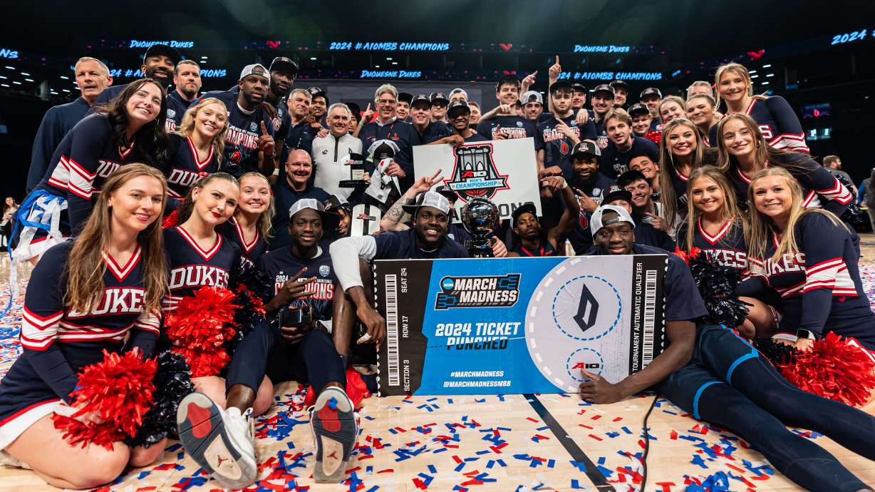 Duquesne players, cheerleaders and team staff pose after an NCAA college basketball game against Virginia Commonwealth in the championship of the Atlantic 10 Conference tournament Sunday, March 17, 2024, in New York.