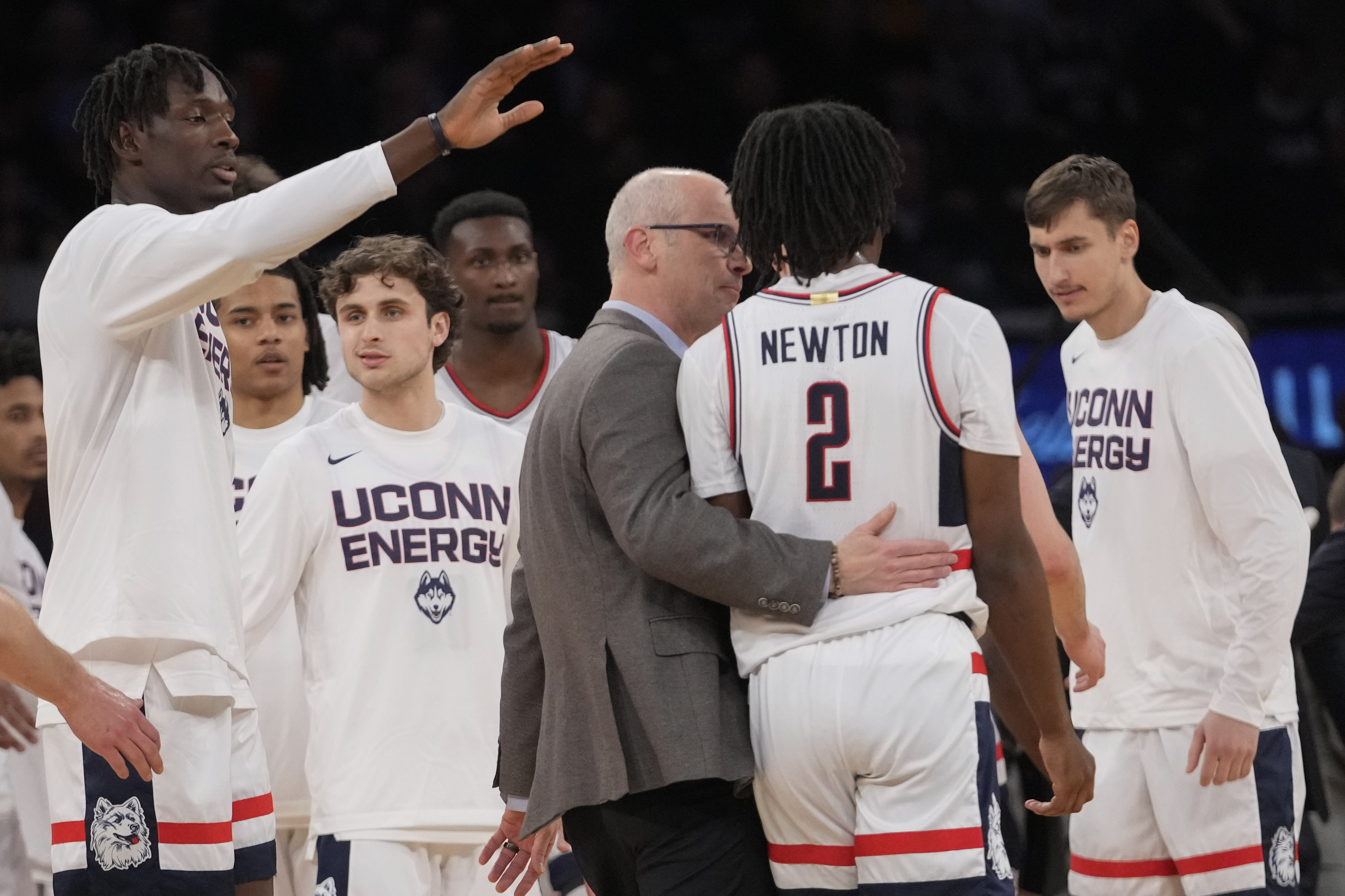 UConn head coach Dan Hurley, center, talks to guard Tristen Newton (2) as he comes to the bench during the first half of an NCAA college basketball game against Marquette in the championship of the Big East Conference tournament, Saturday, March 16, 2024, in New York. 