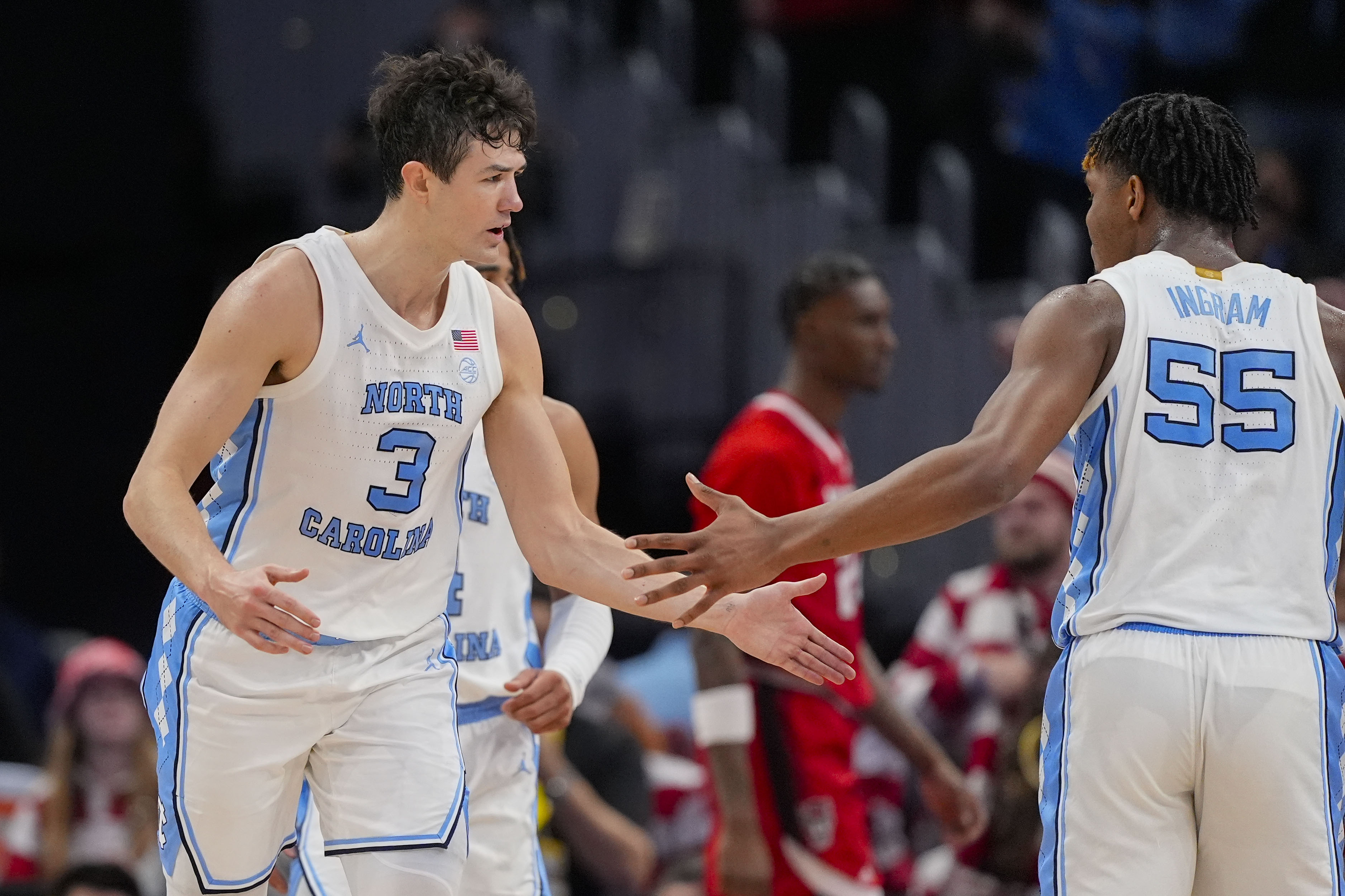 North Carolina guard Cormac Ryan (3) celebrates a three-point shot with teammate North Carolina forward Harrison Ingram (55) during the first half of an NCAA college basketball game against North Carolina State in the championship of the Atlantic Coast Conference tournament, Saturday, March 16, 2024 in Washington. 