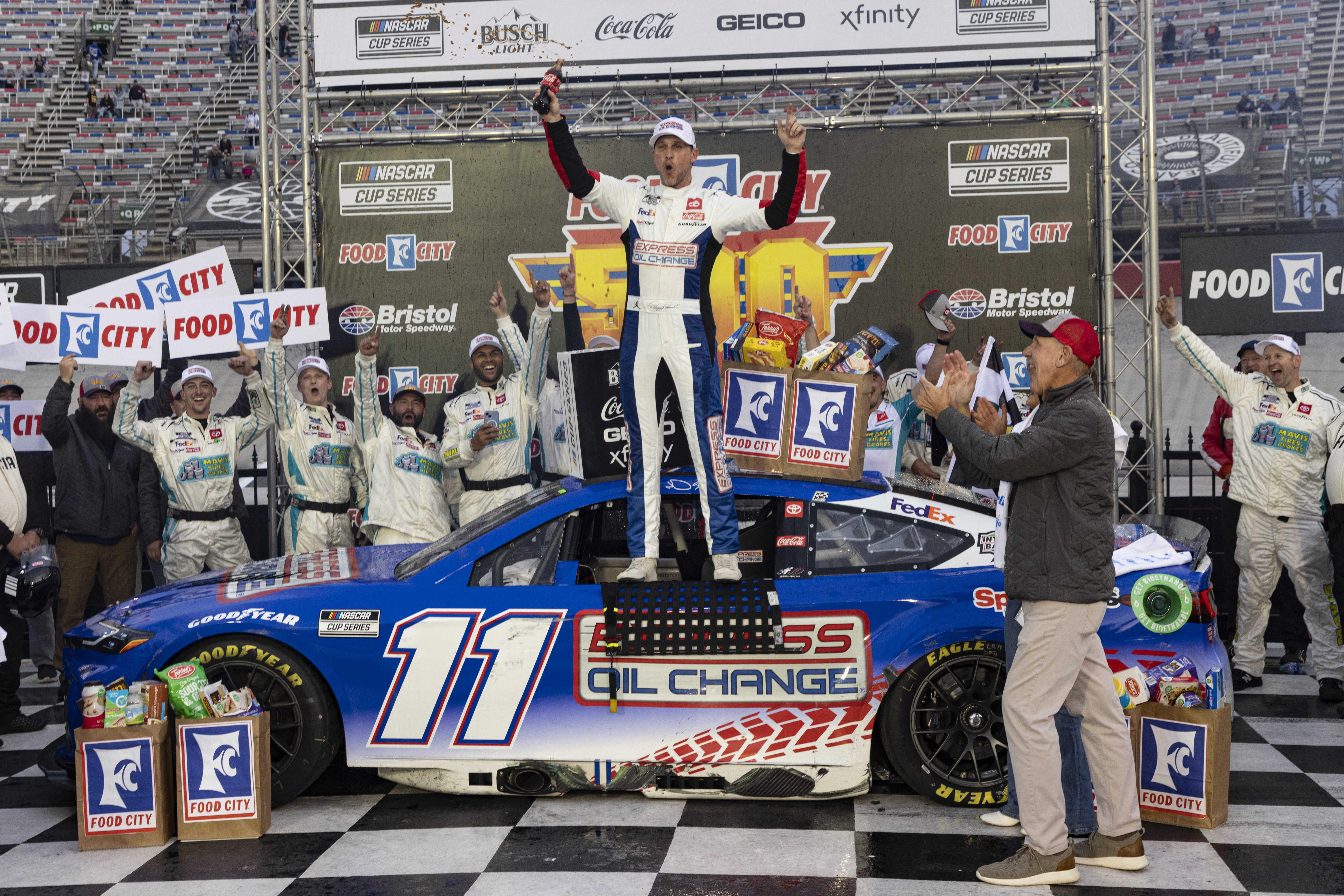 Denny Hamlin, center, celebrates after winning a NASCAR Cup Series auto race, Sunday, March 17, 2024, in Bristol, Tenn. 