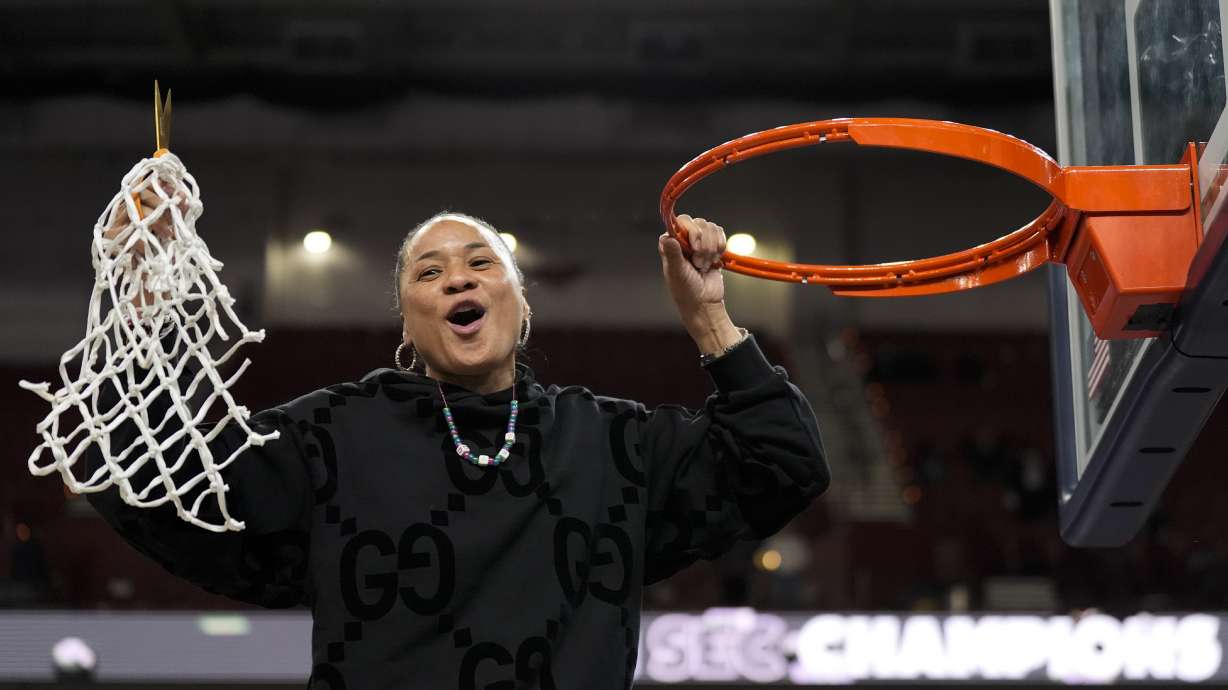 South Carolina head coach Dawn Staley celebrates cutting the net after their win against LSU in an NCAA college basketball game at the Southeastern Conference women's tournament final Sunday, March 10, 2024, in Greenville, S.C.