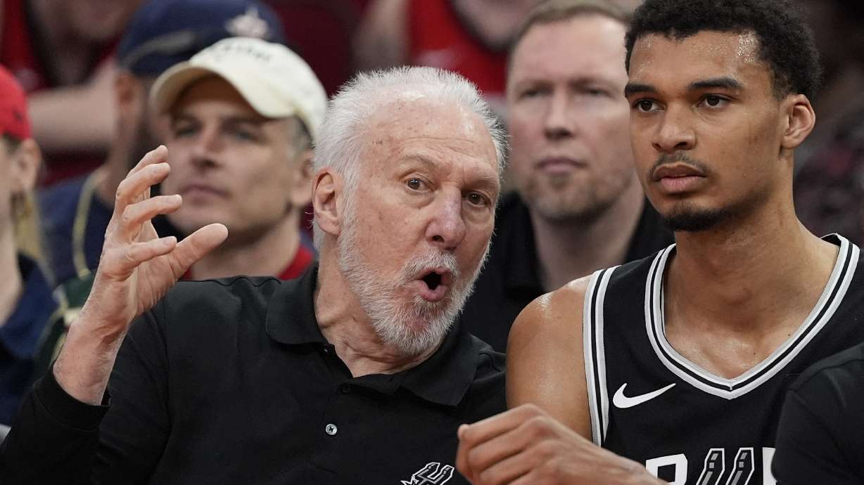 San Antonio Spurs coach Gregg Popovich, left, talks with Victor Wembanyama on the bench during the first half of an NBA basketball game against the Houston Rockets Tuesday, March 5, 2024, in Houston.