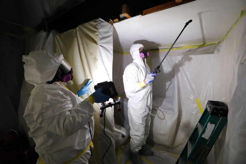 Asbestos Removal Technologies staff work on asbestos abatement in Howell, Mich., Oct. 18, 2017. The Environmental Protection Agency on Monday announced a comprehensive ban on asbestos.