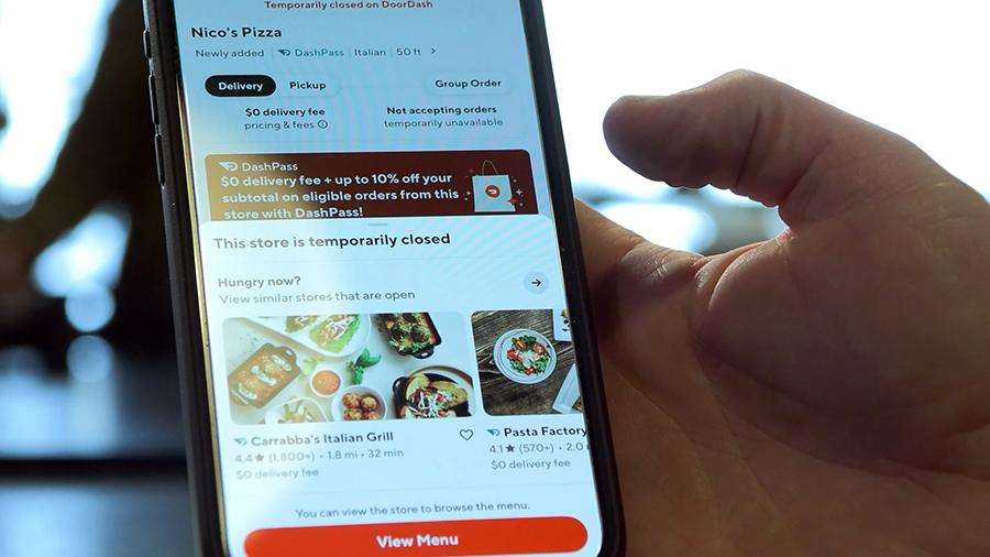 Nico’s Pizza owner Nate Bertasso shows a message on the DoorDash app saying his restaurant is “temporarily closed.”