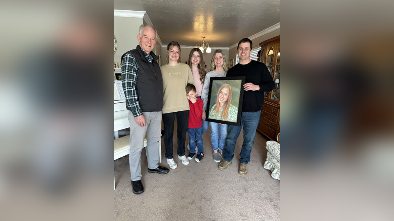 The Beagley family opens a portrait of their daughter who died in a tubing accident.