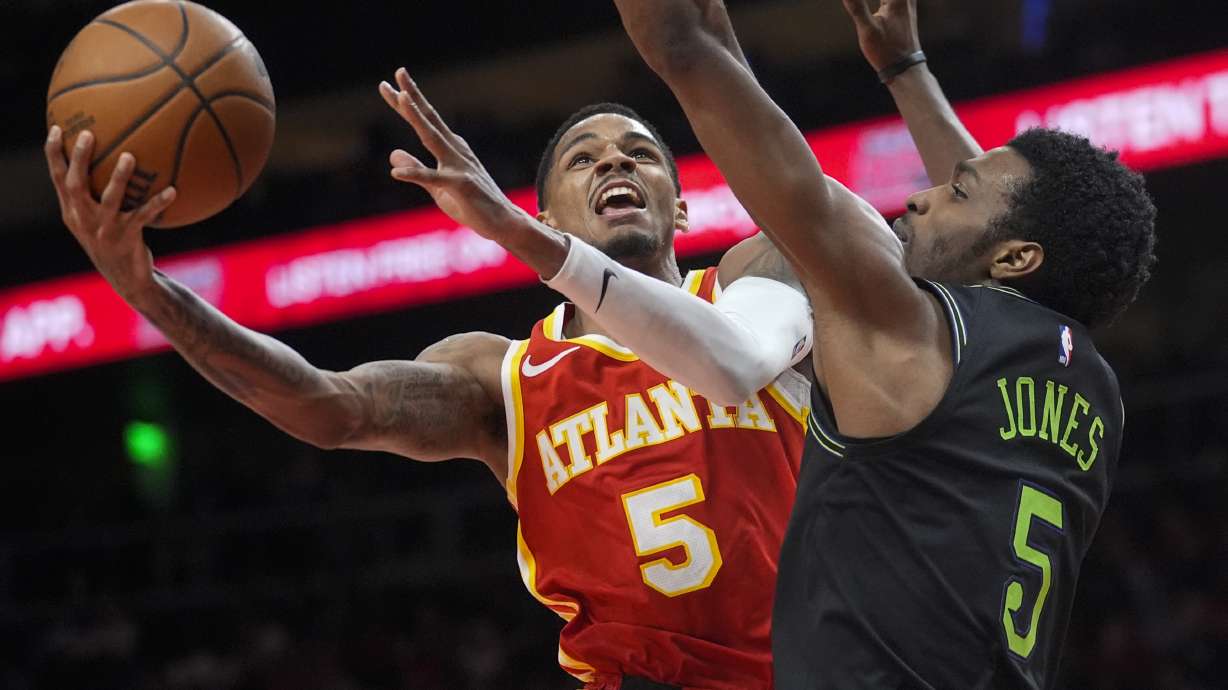 Atlanta Hawks guard Dejounte Murray (5) goes in for a shot as New Orleans Pelicans forward Herbert Jones (5) defends during the second half of an NBA basketball game Sunday, March 10, 2024, in Atlanta.