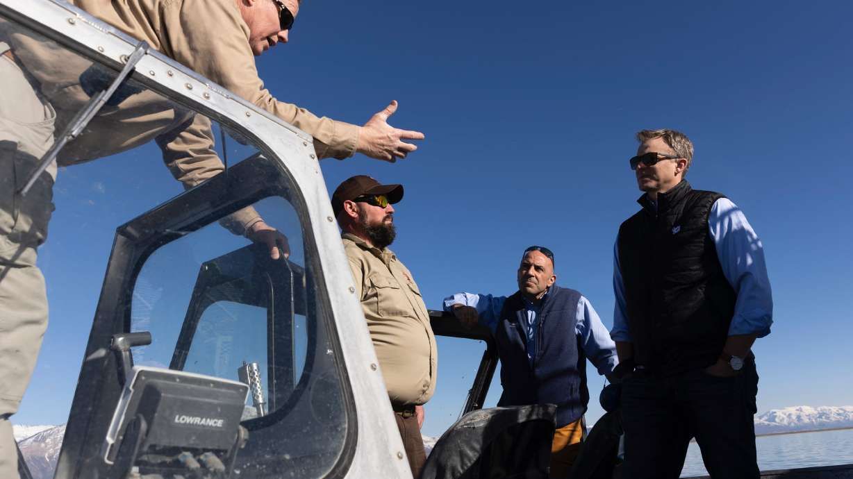 John Luft, Great Salt Lake Ecosystem Program manager, and Kyle Stone, wildlife biologist for the Division of Wildlife Resources, speak with Utah Rep. Blake Moore and California Rep. Jimmy Panetta during a tour of the Great Salt Lake in Willard on Monday.