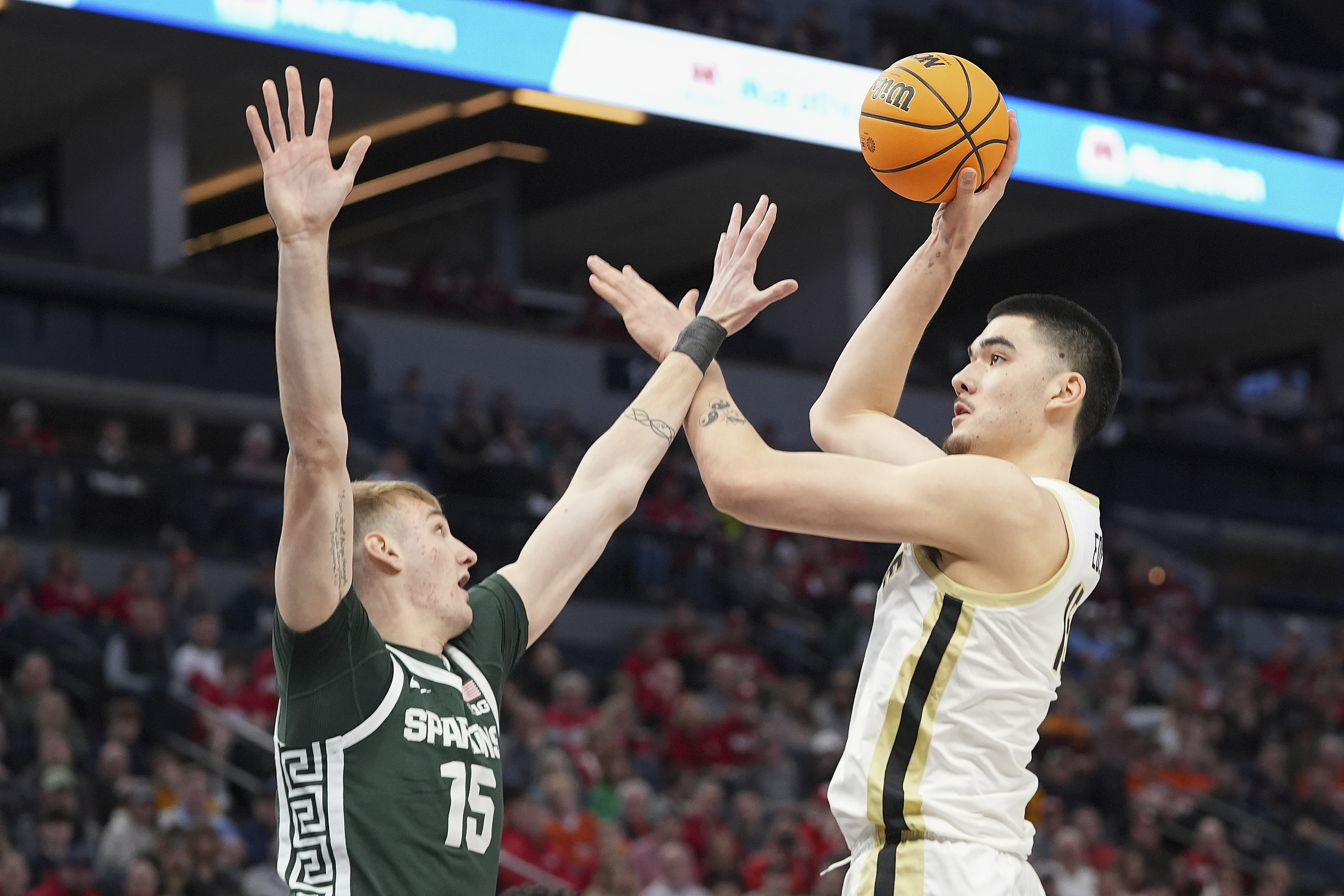 Purdue center Zach Edey, right, shoots over Michigan State center Carson Cooper (15) during the first half of an NCAA college basketball game in the quarterfinal of the Big Ten Conference tournament, Friday, March 15, 2024, in Minneapolis. 