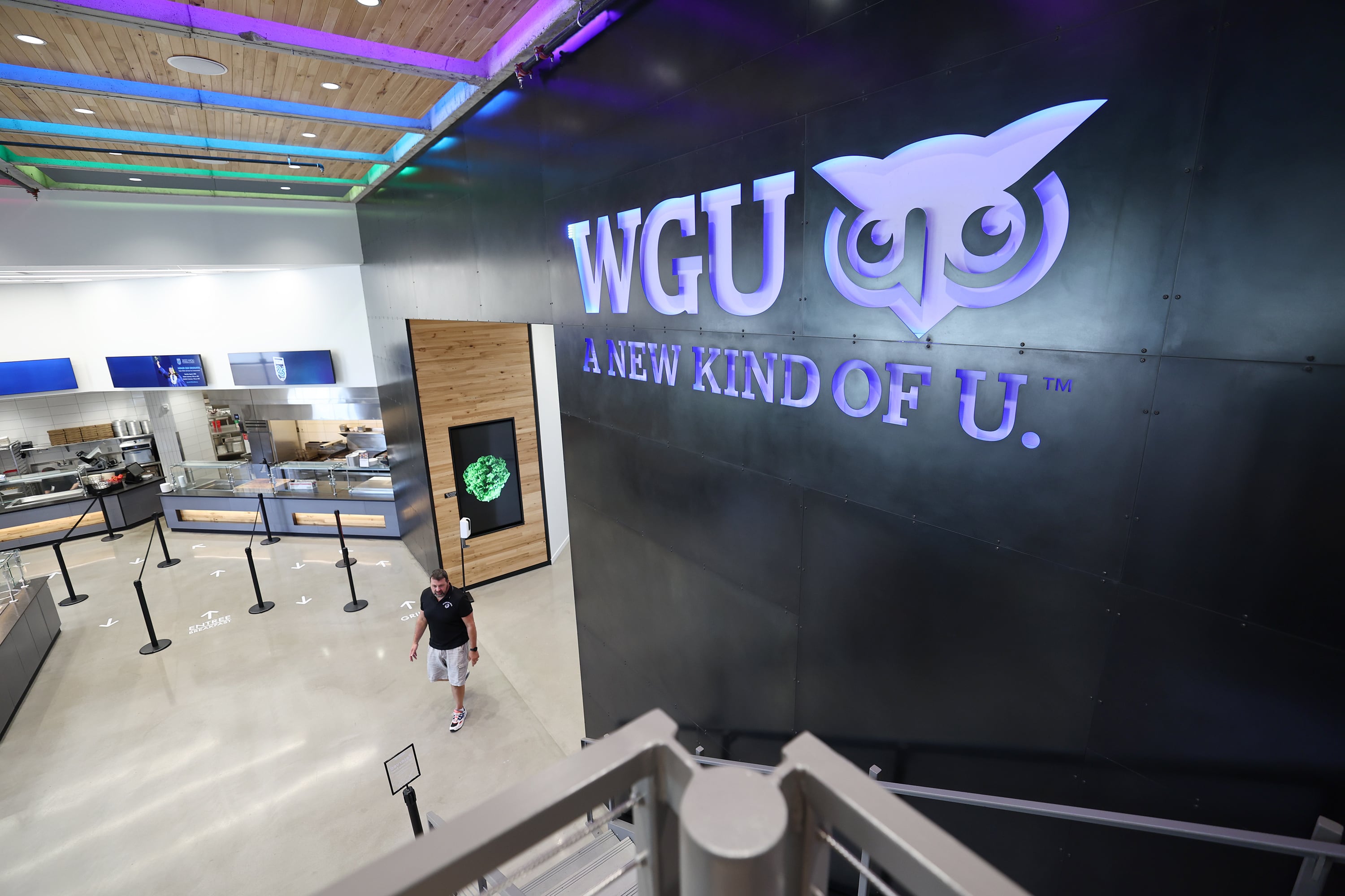 A person walks through the cafeteria at Western Governors University in Millcreek on Wednesday, Aug. 3, 2022, the school's 25th anniversary.