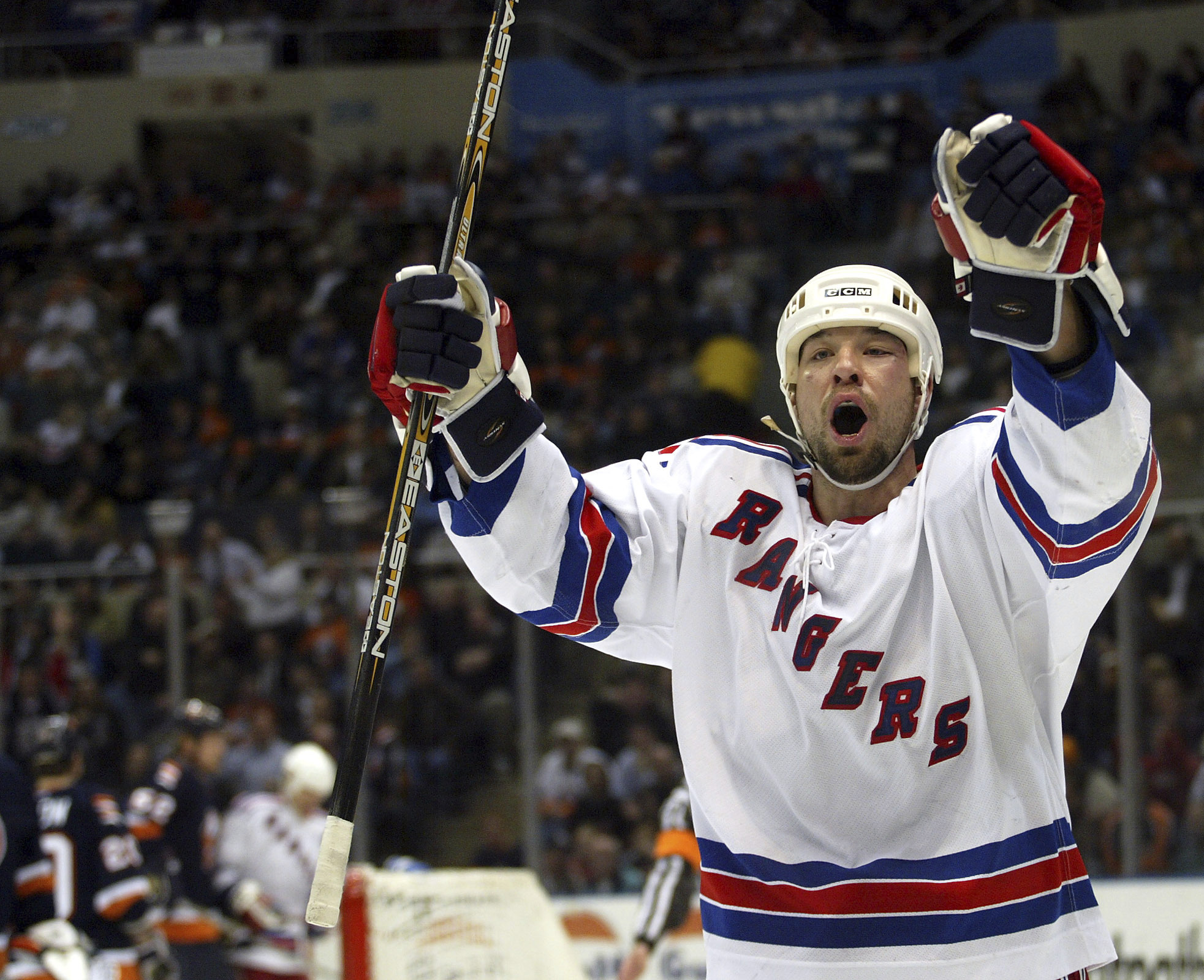 FILE - New York Rangers' Chris Simon celebrates his second-period goal against the New York Islanders, Thursday, Feb. 26, 2004, at Nassau Coliseum in Uniondale, N.Y. Former NHL enforcer Chris Simon has died. He was 52. Simon died Monday night, March 18, 2024, according to a spokesperson for the NHL Players' Association.