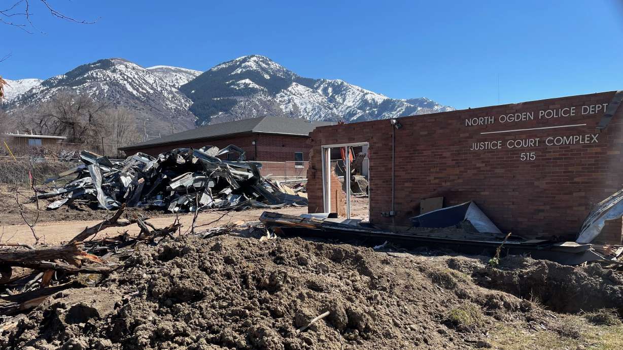 The old North Ogden Police Department and municipal court structure, partially demolished, sits adjacent to the replacement building, in the rear of the photo, on Monday,