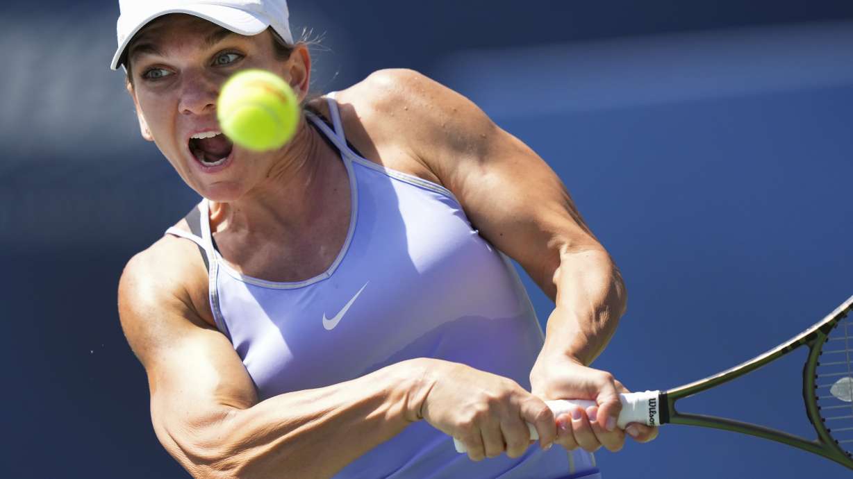 FILE - Simona Halep, of Romania, returns the ball to Beatriz Haddad Maia, of Brazil, during the final of the National Bank Open tennis tournament in Toronto, Aug. 14, 2022. Halep returned to professional tennis after successfully reducing a doping suspension on appeal, playing her first match in about 1 1/2 years Tuesday, March 19 — a 1-6, 6-4, 6-3 loss to Paula Badosa at the Miami Open.