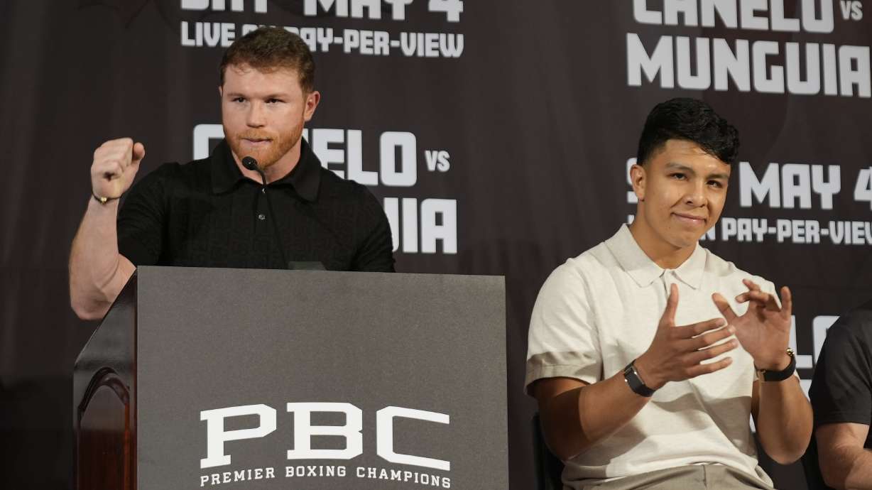Undisputed super middleweight champion Canelo Alvarez, left, celebrates for Mexico with boxer Jaime Munguía during a news conference in Beverly Hills, Calif., Tuesday, March 19, 2024. Alvarez will defend his titles against All-Action Star Jaime Munguía on Saturday, May 4, at T-Mobile Area in Las Vegas.