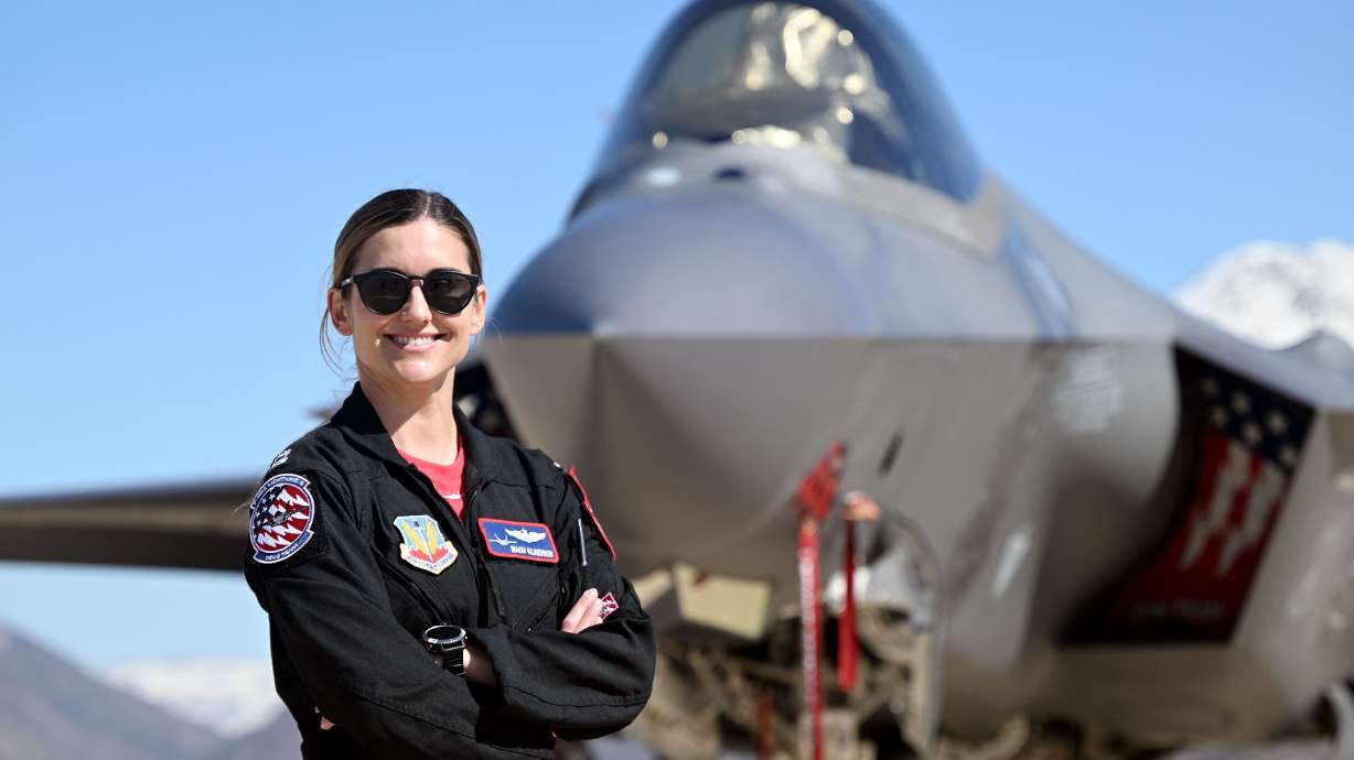 F-35A Lightning II Demonstration Team commander Capt. Melanie “MACH” Kluesner poses for photos in front of her plane at Hill Air Force Base near Ogden on Tuesday.