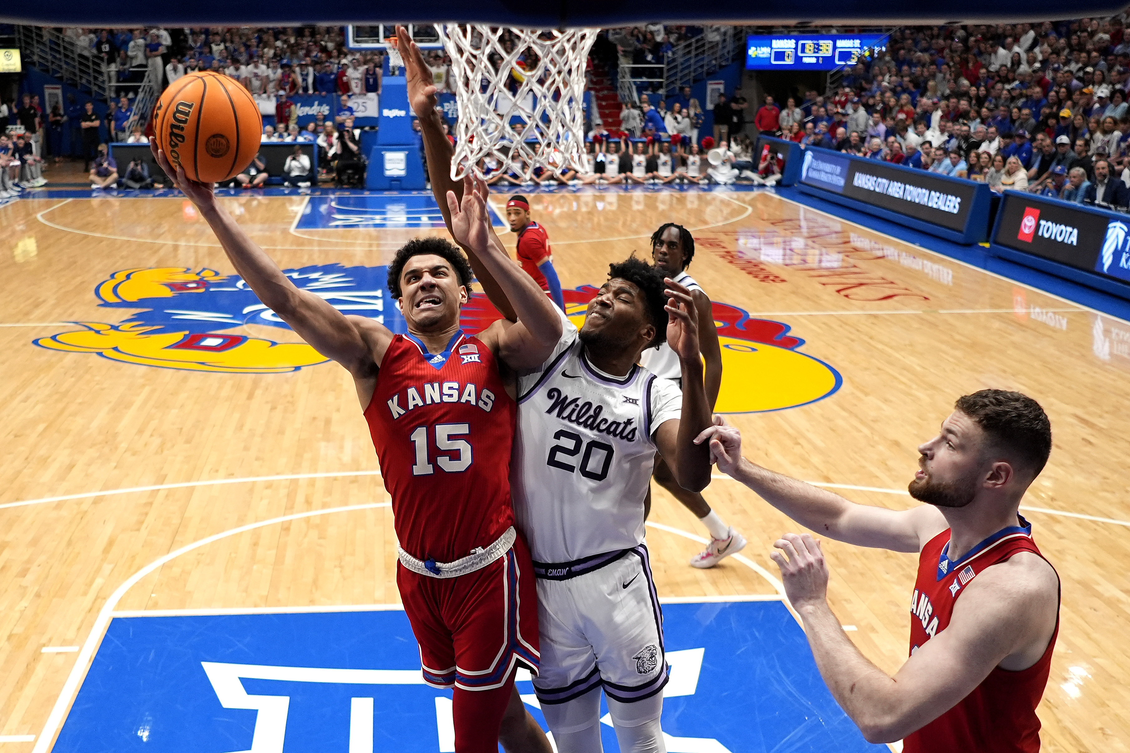 Kansas guard Kevin McCullar Jr. (15) shoots under pressure from Kansas State forward Jerrell Colbert (20) during the first half of an NCAA college basketball game Tuesday, March 5, 2024, in Lawrence, Kan. 
