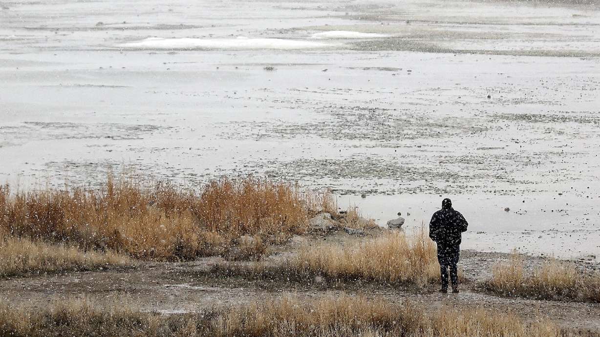 A man looks out over the shoreline at Great Salt Lake State Park in Salt Lake County on Feb. 7. The lake's southern arm is already back to its 2023 peak and could reach 4,195 feet elevation this year for the first time since 2019, experts say.