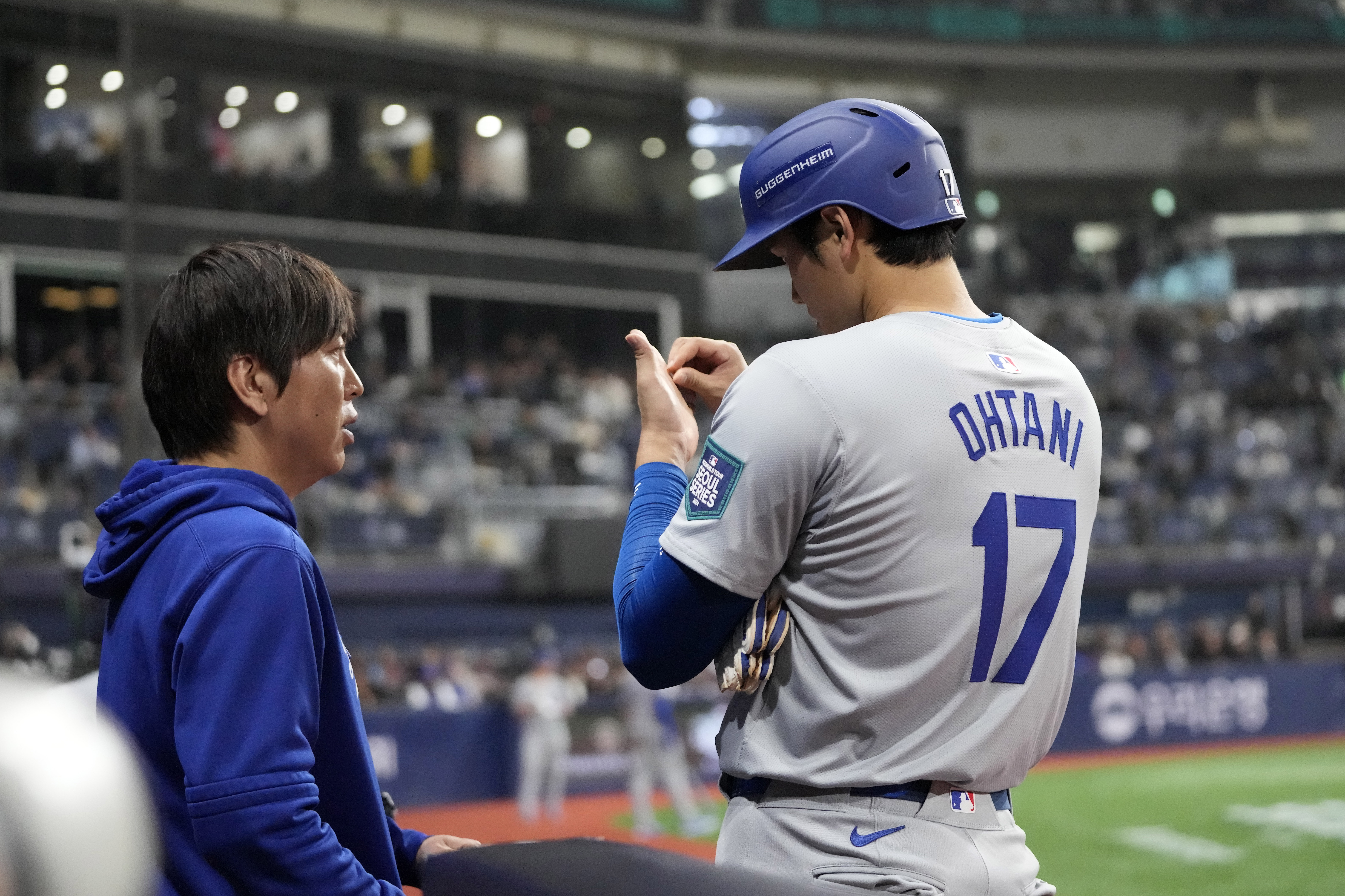 Los Angeles Dodgers designated hitter Shohei Ohtani, right, talks to his interpreter Ippei Mizuhara during the fifth inning of an opening day baseball game against the San Diego Padres at the Gocheok Sky Dome in Seoul, South Korea Wednesday, March 20, 2024, in Seoul, South Korea.