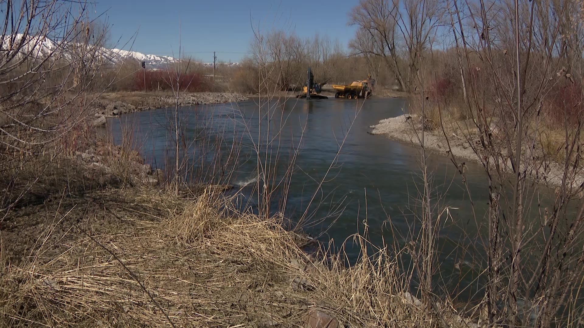 One of the Logan ponds is seen as workers move sediment out of it Wednesday.