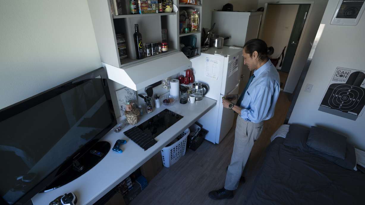 Cheyenne Welbourne stands in his micro-apartment at The Starlight affordable housing building that is run by Central City Concern, a Portland-based homeless services nonprofit, on March 15 in Portland, Ore.