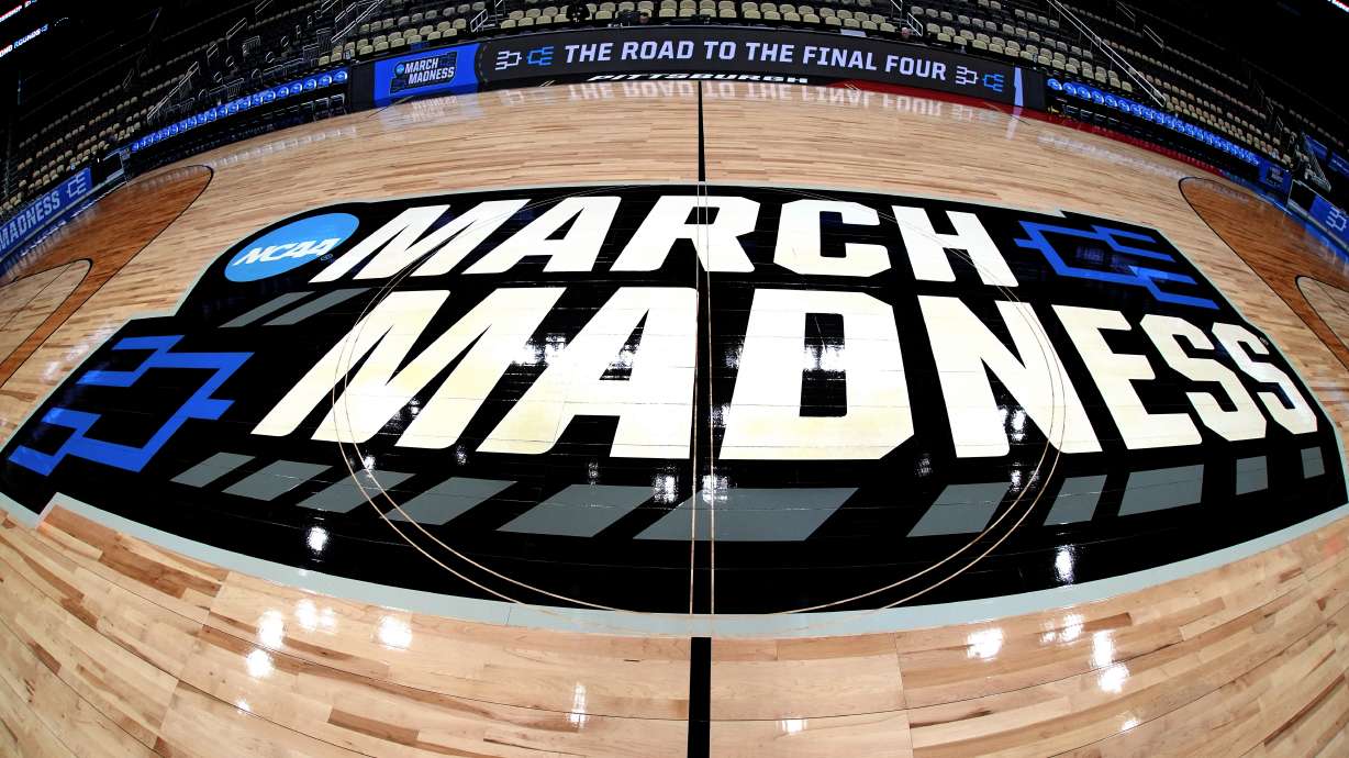 This is the NCAA March Madness logo at center court before a practice day for NCAA college men's basketball teams participating in the first and second round tournament games at PPG Paints Arena in Pittsburgh, Wednesday, March 20, 2024. First round games will be played Thursday, and second round games will be played Saturday.