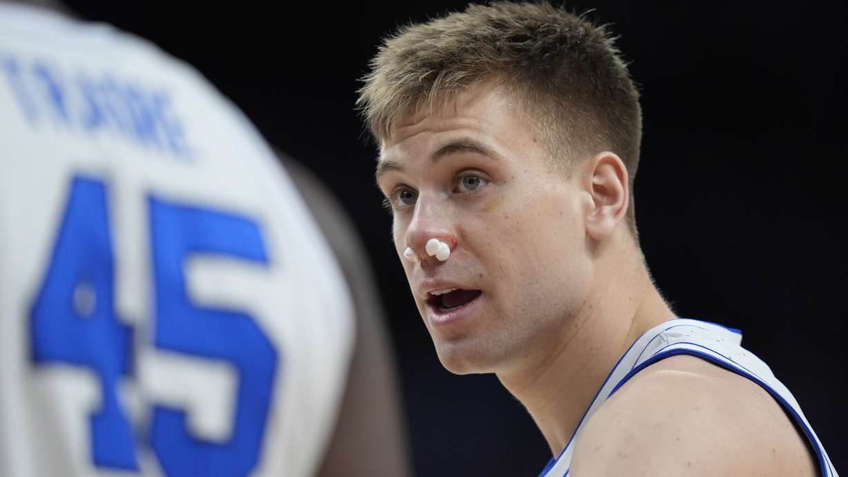 BYU guard Dallin Hall (30) returns to the game after being injured in the first half of a first-round college basketball game against Duquesne in the NCAA Tournament, Thursday, March 21, 2024, in Omaha, Neb.