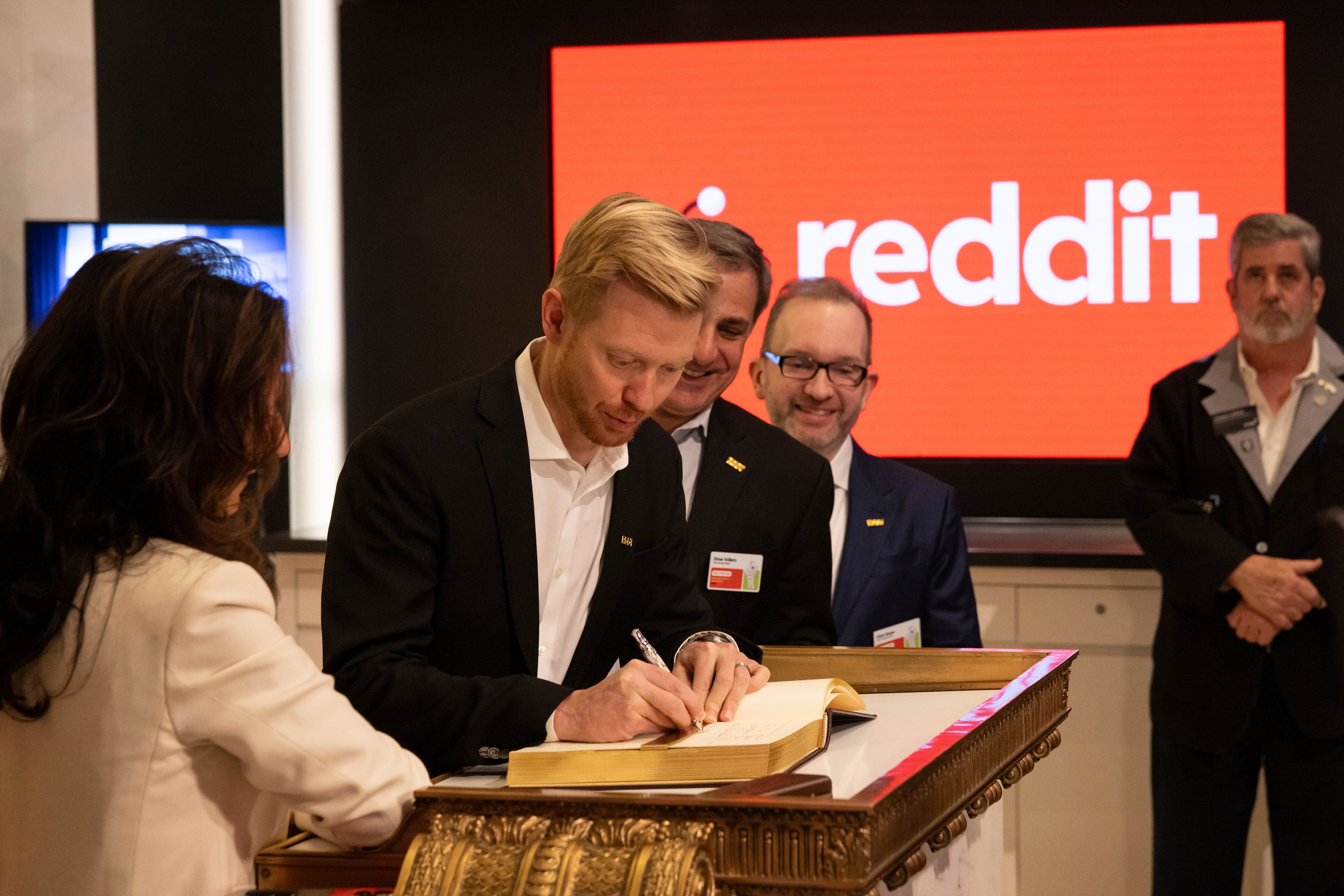 Reddit CEO Steve Huffman signs a book on the New York Stock Exchange on Thursday. The market debut is likely to spur a flurry of commentary on Reddit’s own platform, as well as competing social media outlets.