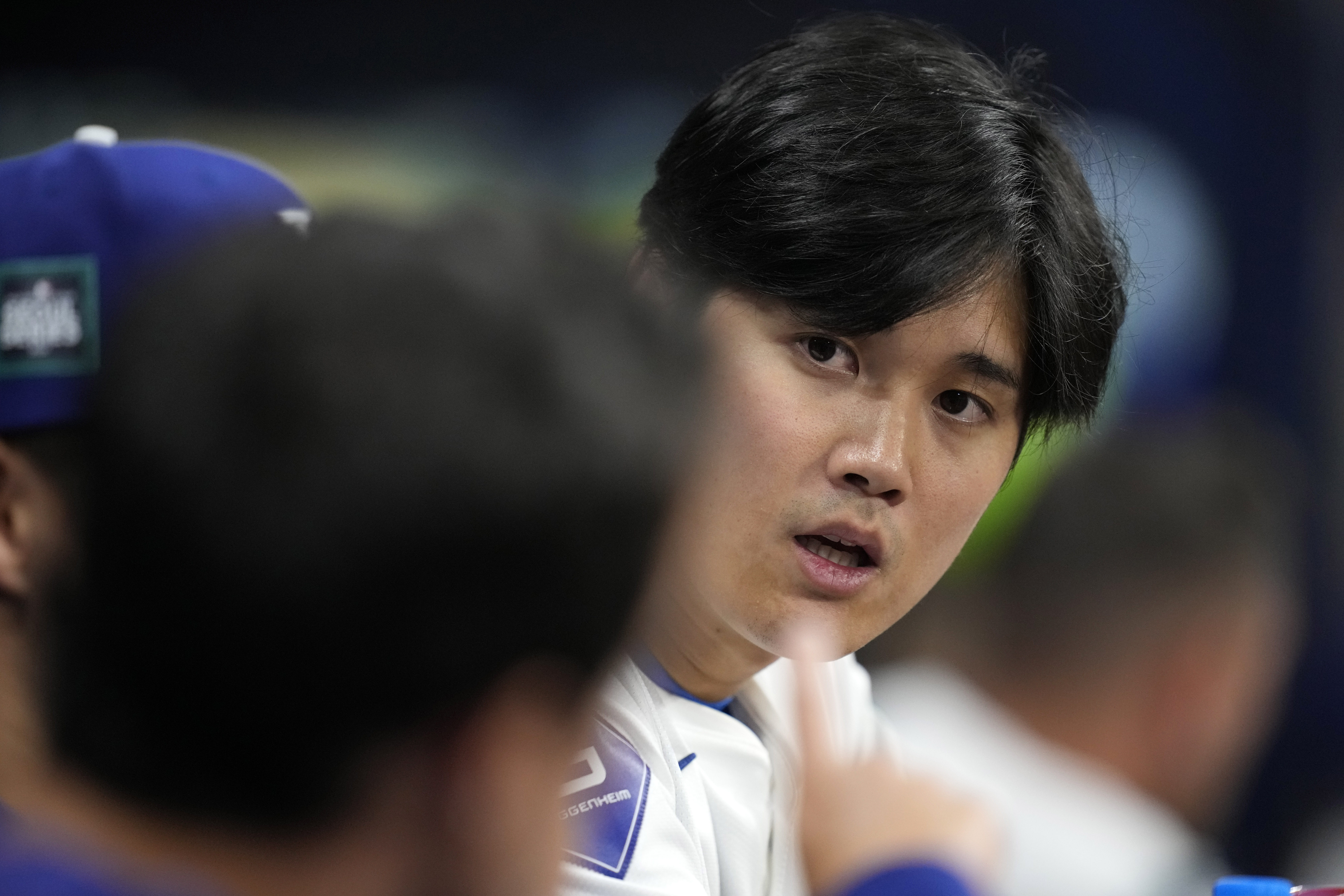 Los Angeles Dodgers designated hitter Shohei Ohtani, right, talks with interpreter Will Ireton during the fourth inning of a baseball game against the San Diego Padres at the Gocheok Sky Dome in Seoul, South Korea Thursday, March 21, 2024, in Seoul, South Korea.