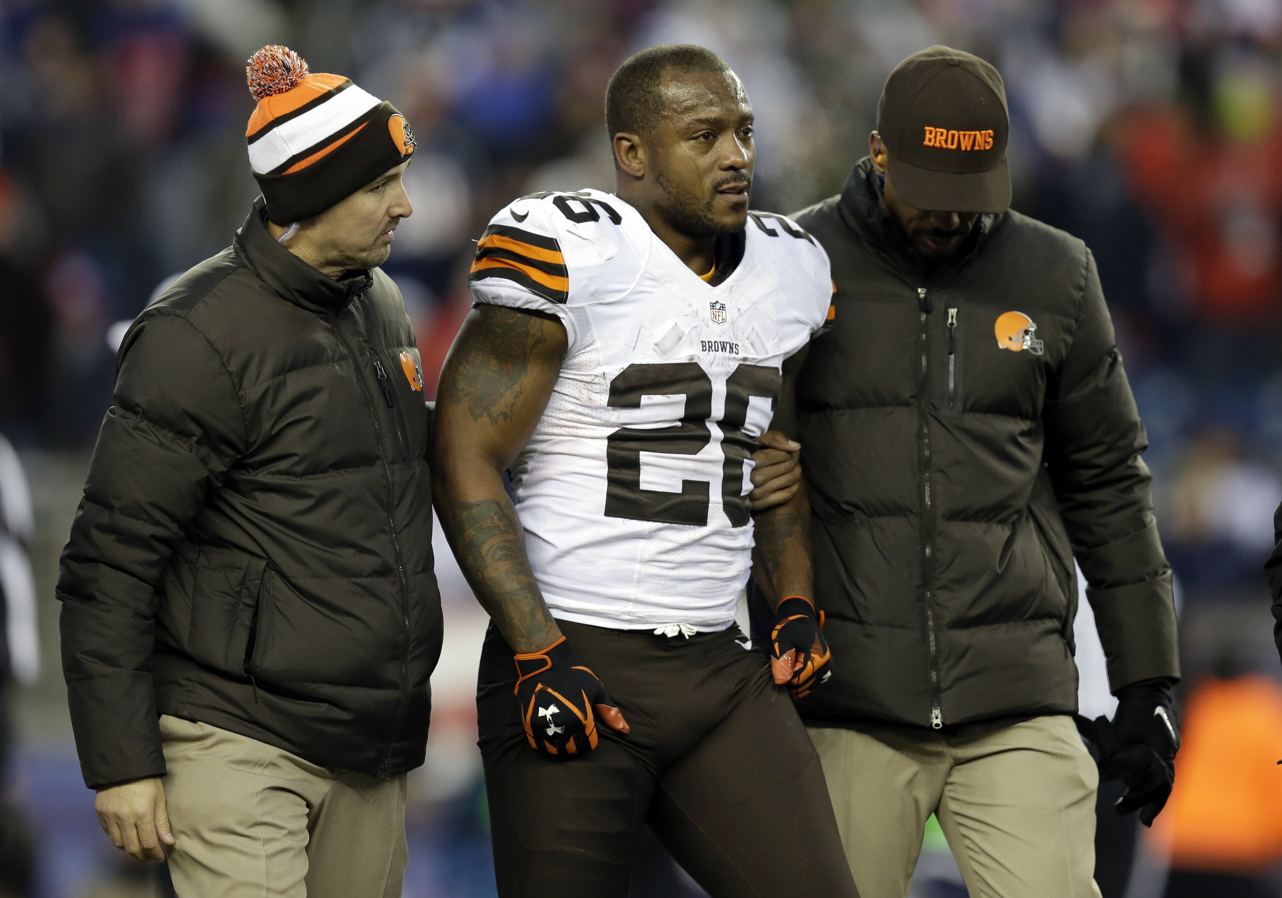 FILE - Cleveland Browns running back Willis McGahee is helped from the field after getting injured in the fourth quarter of an NFL football game against the New England Patriots on Dec. 8, 2013, in Foxborough, Mass. Ten retired NFL players, including McGahee, accused the league of lies, bad faith and flagrant violations of federal law in denying disability benefits in a potential class action lawsuit filed Thursday, Feb. 9, 2023, in Baltimore. A federal judge in Maryland on Thursday, March 21, 2024, refused to dismiss a lawsuit that accuses the NFL of flagrantly violating the league's disability plan by denying valid claims.