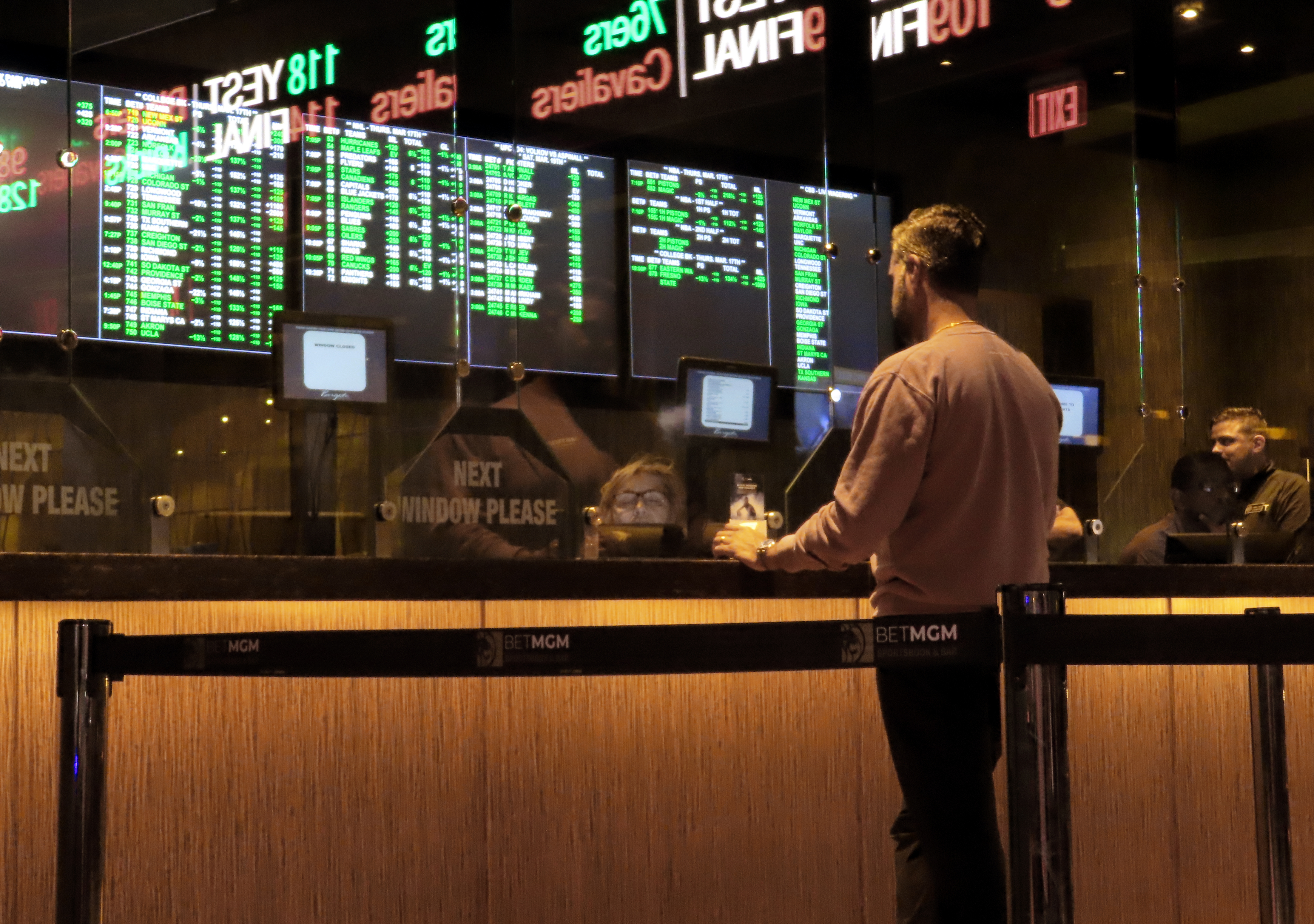 FILE - A customer makes a sports bet at the Borgata casino in Atlantic City N.J. on March 17, 2022 just before the March Madness NCAA college basketball tournament began. As March Madness gets underway, more people than ever now can legally bet on sports. A total of 38 states and the District of Columbia now allow some form of sports betting. 