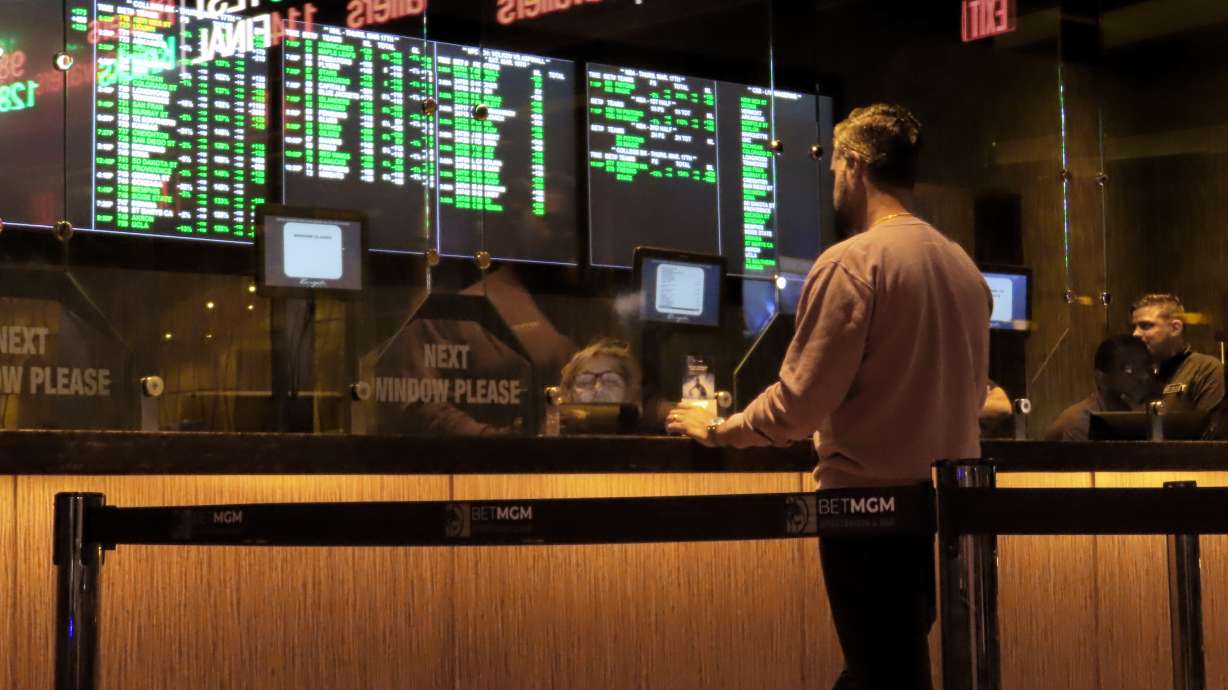 FILE - A customer makes a sports bet at the Borgata casino in Atlantic City N.J. on March 17, 2022 just before the March Madness NCAA college basketball tournament began. As March Madness gets underway, more people than ever now can legally bet on sports. A total of 38 states and the District of Columbia now allow some form of sports betting.