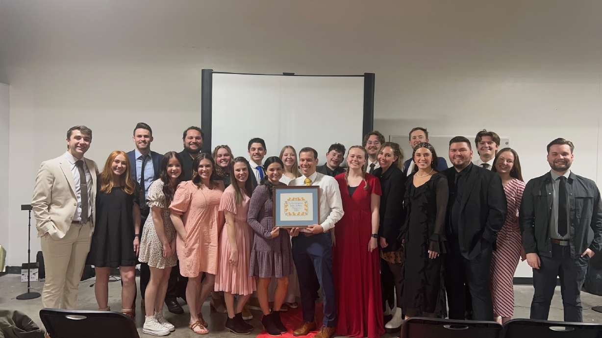 Ty Nelson poses with his cross-stitch art and his avid fans at a movie premiere in Provo on March 13.