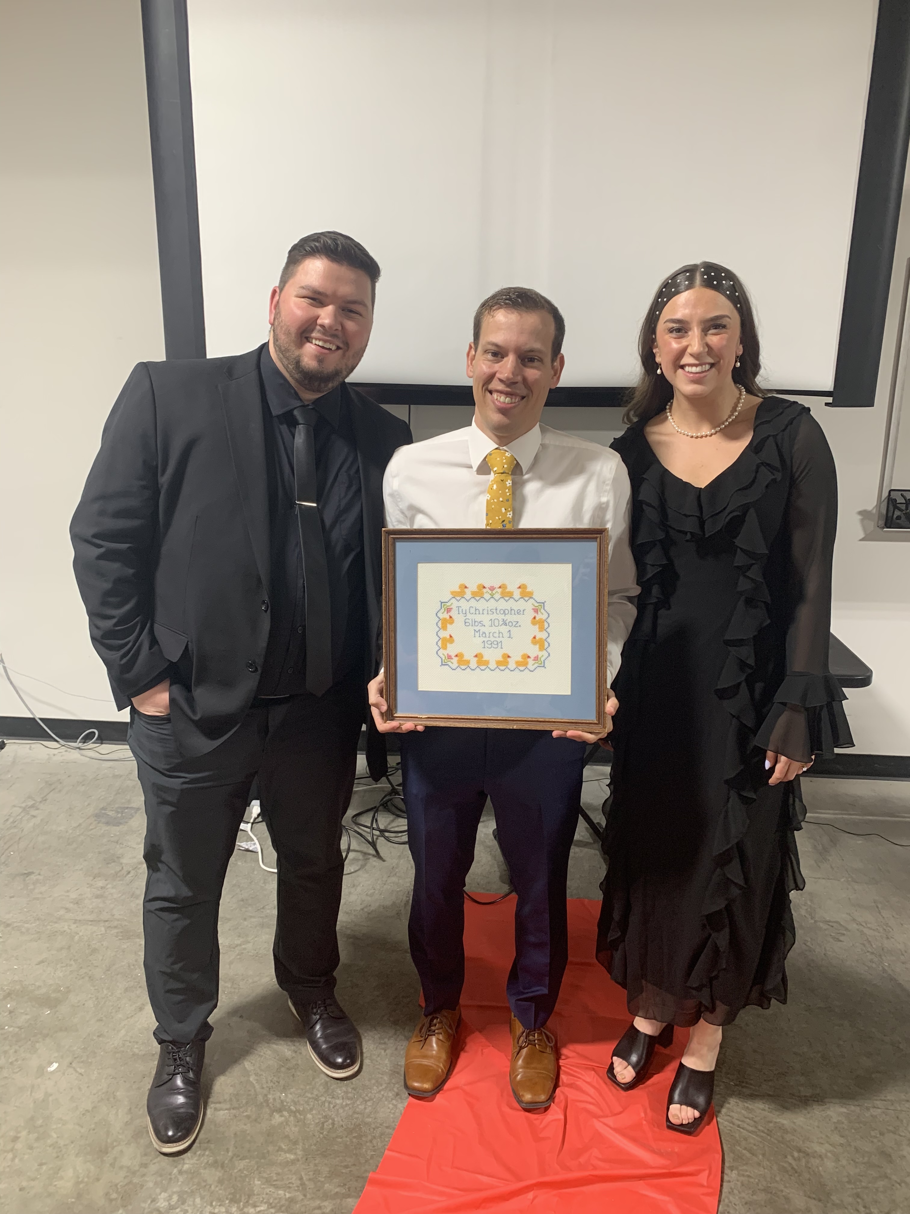 Brigham Tingey and his wife Makenna Tingey pose with Ty Nelson at a movie premiere in Orem on March 13.