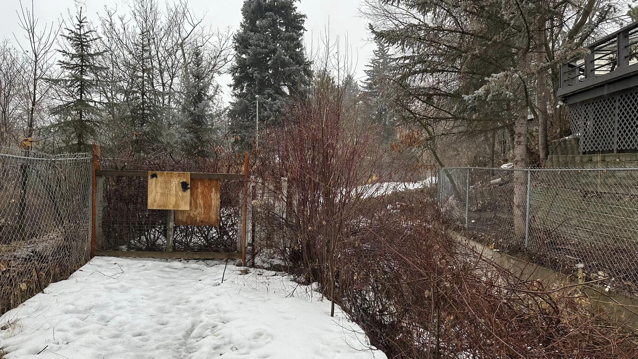 A fence built across a Logan canal trail in January, blocking a key connection into the city.