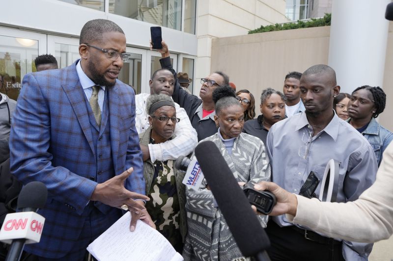 Civil co-counsel Malik Shabazz, left, speaks with reporters, accompanied by Eddie Terrell Parker and his aunt Linda Rawls, second from left, Mary Jenkins and her son Michael Corey Jenkins, outside the federal courthouse in Jackson, Miss., Thursday, following the sentencing of former Rankin County deputy Brett McAlpin to more than 27 years in federal prison for his role in the racially motivated, violent torture of Parker and Jenkins last year.