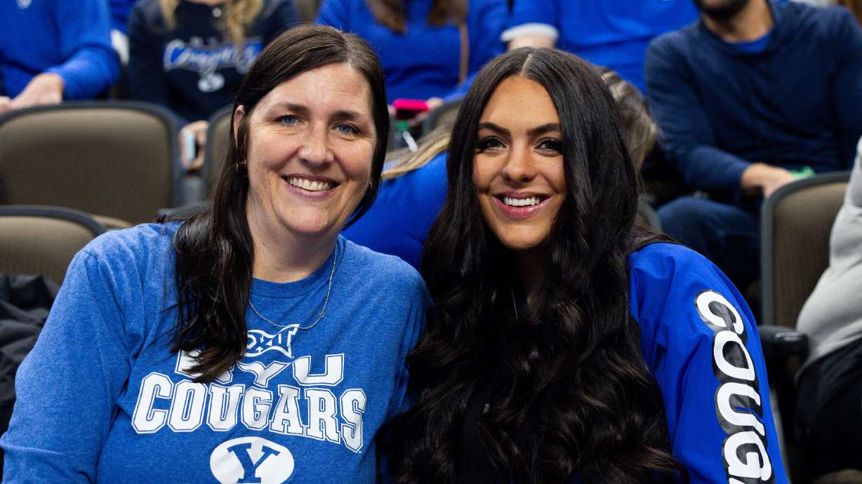 Emily Johnson, mother of Brigham Young guard Spencer Johnson, and Isabella Johnson, his wife, attend the game between BYU and the Duquesne Dukes in the first round of the 2024 NCAA Tournament in Omaha on Thursday.