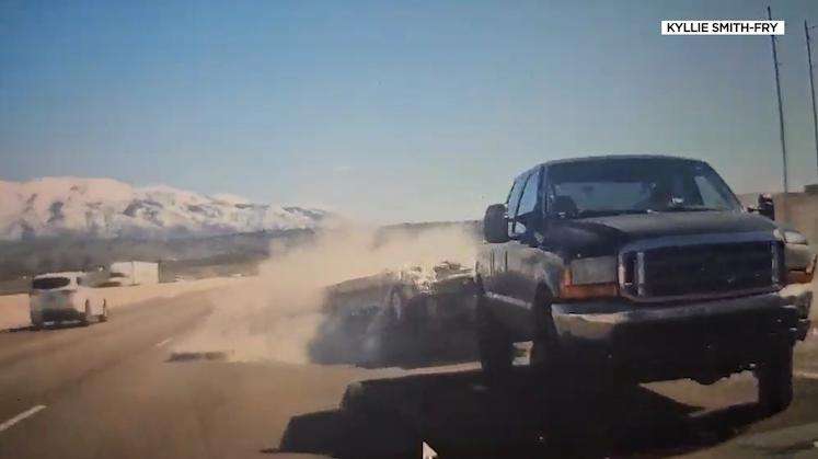 An unsecured load spills onto I-15 as drivers work to avoid the spun-out truck Wednesday.