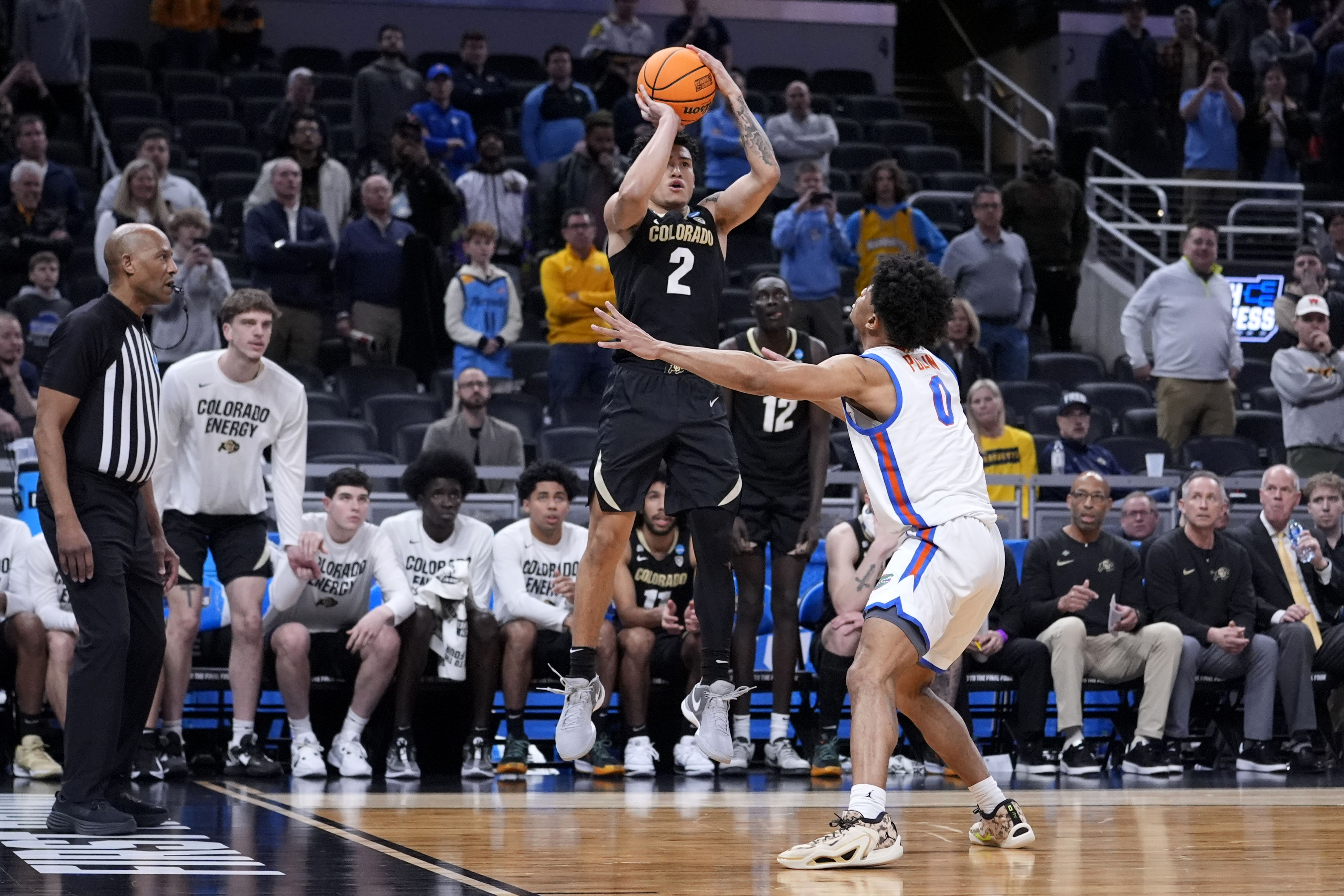 Colorado guard KJ Simpson (2) shoots over Florida guard Zyon Pullin (0) at the end of a first-round college basketball game in the NCAA Tournament, Friday, March 22, 2024, in Indianapolis. Colorado won 102-100. 