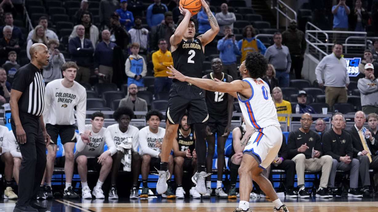 Colorado guard KJ Simpson (2) shoots over Florida guard Zyon Pullin (0) at the end of a first-round college basketball game in the NCAA Tournament, Friday, March 22, 2024, in Indianapolis. Colorado won 102-100.