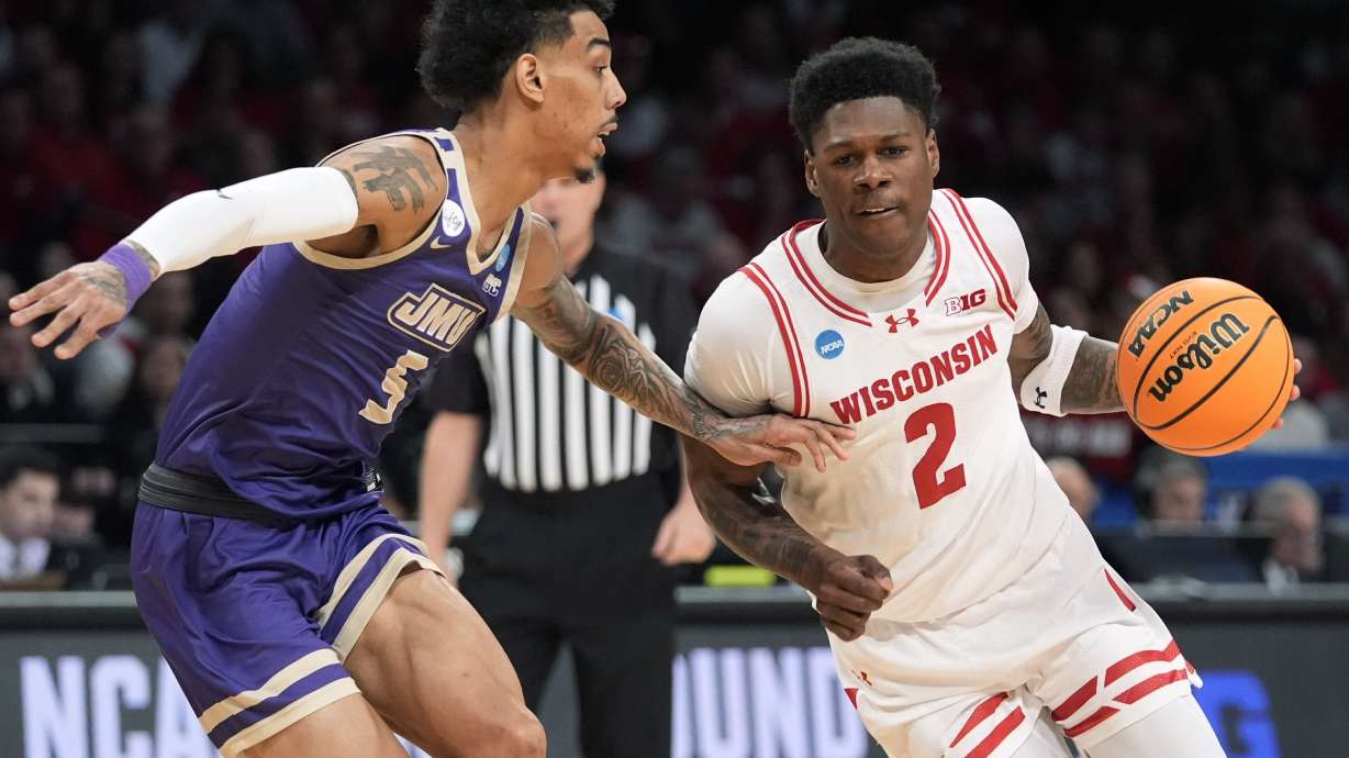 Wisconsin guard AJ Storr (2) drives against James Madison guard Terrence Edwards Jr. (5) during the first half of a first-round college basketball game in the men's NCAA Tournament, Friday, March 22, 2024, in New York.