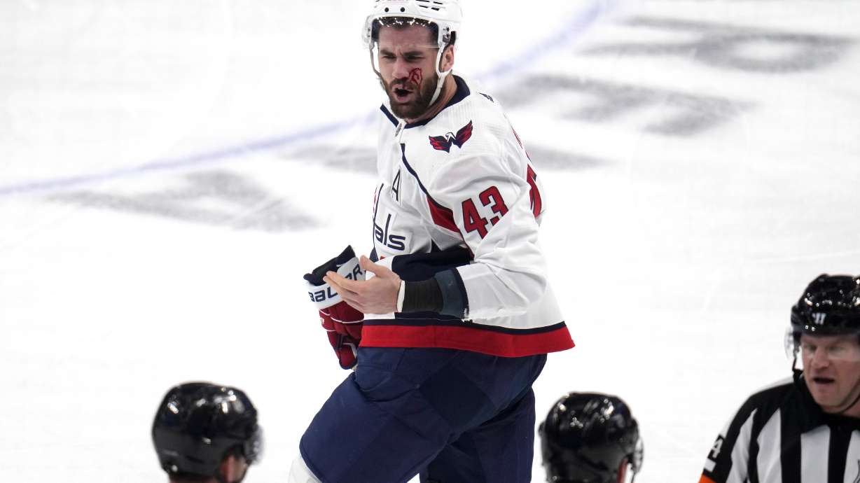 Washington Capitals' Tom Wilson (43) heads to the locker room after getting a high stick to the face from Pittsburgh Penguins' Ryan Graves during the first period of an NHL hockey game in Pittsburgh, Thursday, March 7, 2024. Wilson returned to the game later in the period.