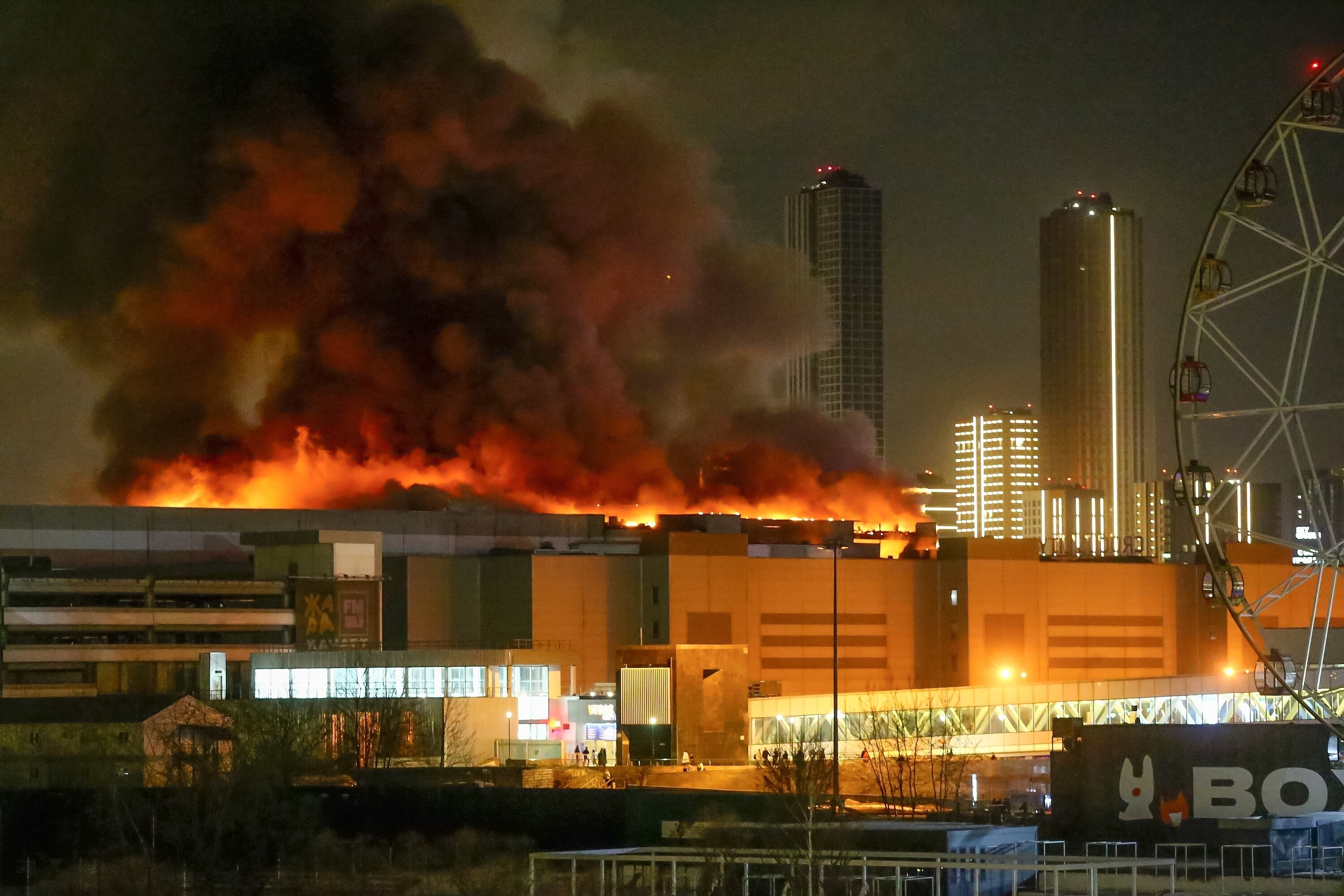 A massive blaze is seen over the Crocus City Hall on the western edge of Moscow, Friday. Several gunmen have burst into a big concert hall in Moscow and fired automatic weapons at the crowd, injuring an unspecified number of people and setting a massive blaze in a terror attack.