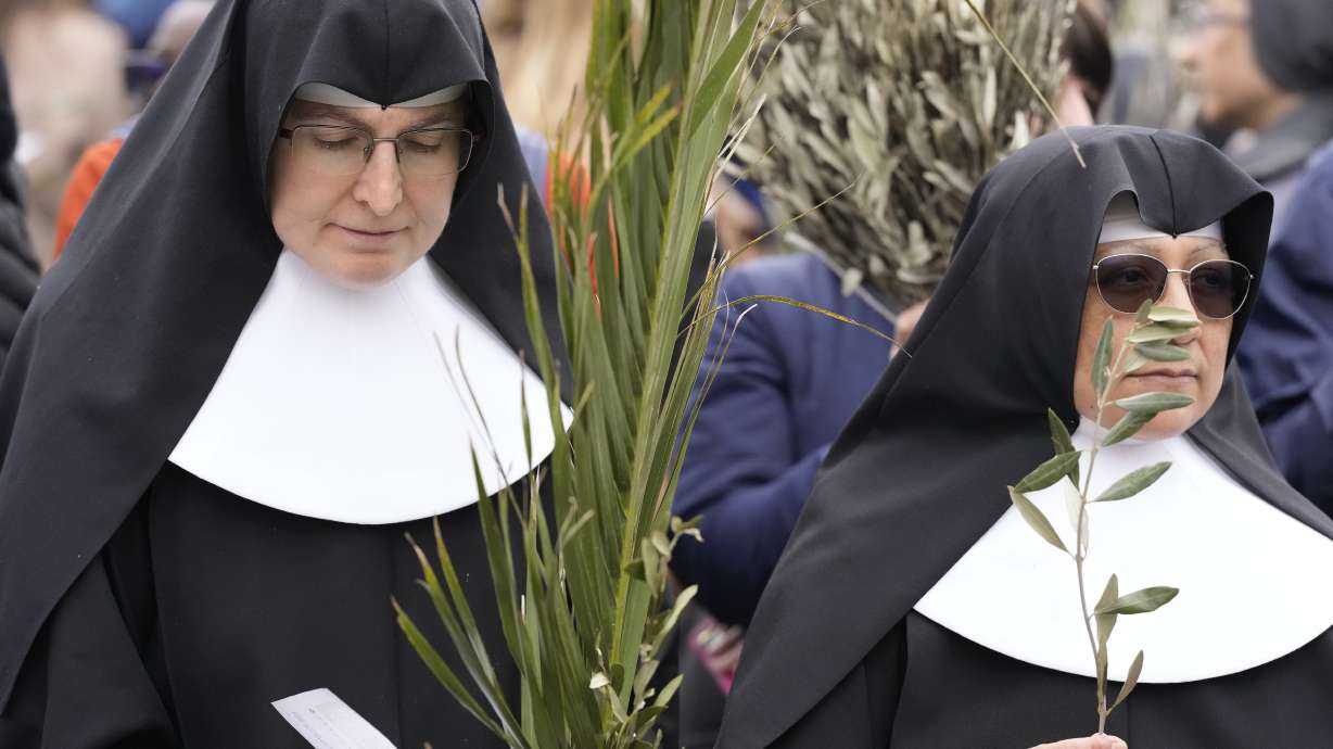 Nuns wait for the start of the Palm Sunday's mass celebrate by Pope Francis in St. Peter's Square at The Vatican, April 2, 2023. Palm Sunday will be celebrated by Christians worldwide Sunday. It commemorates the Christian belief in the triumphant entry of Jesus into Jerusalem, when palm branches were strewn before him. It marks the start of Holy Week.