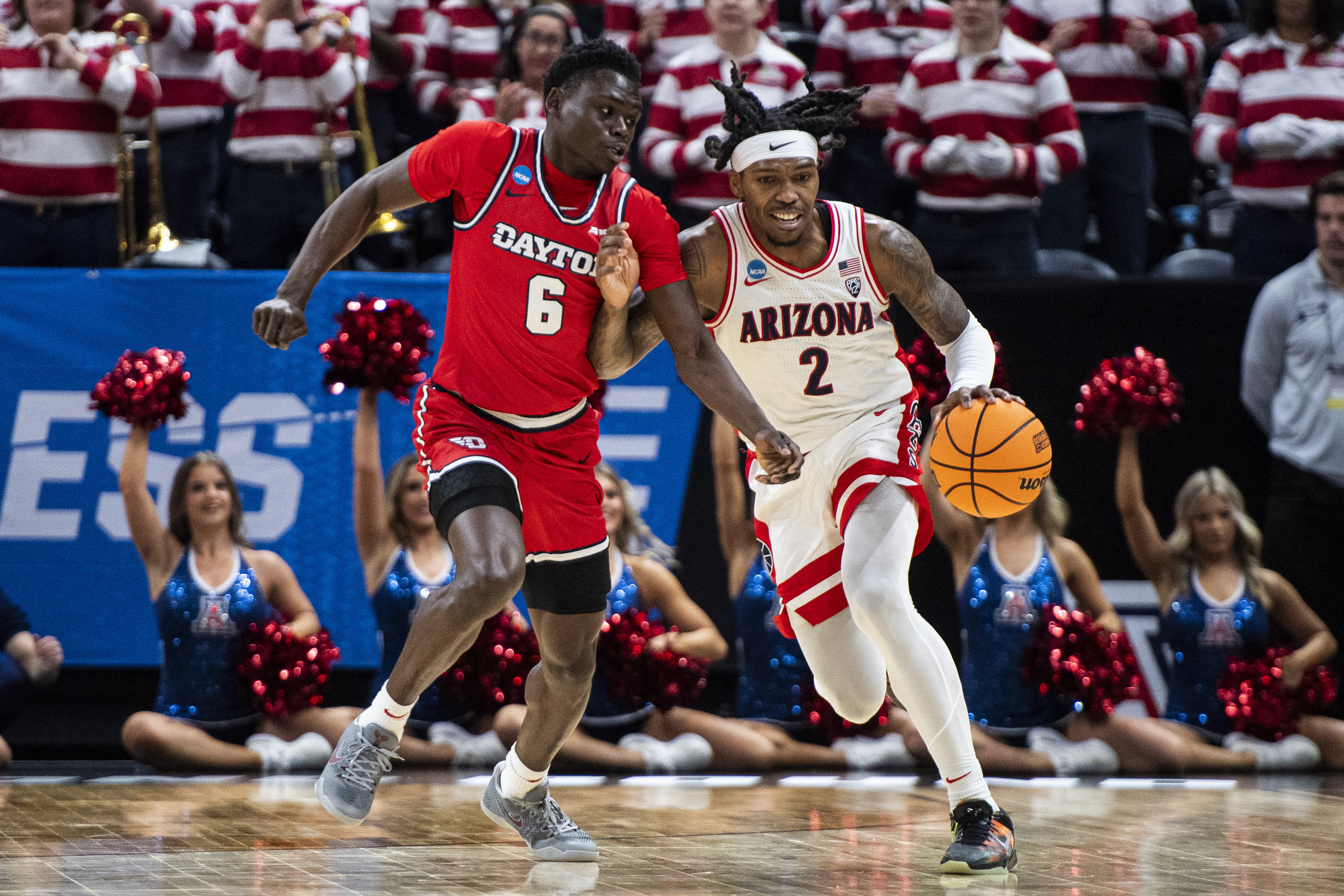 Arizona guard Caleb Love (2) brings the ball up court while guarded by Dayton guard Enoch Cheeks (6) during the first half of a second-round college basketball game in the NCAA Tournament in Salt Lake City, Saturday, March 23, 2024. 