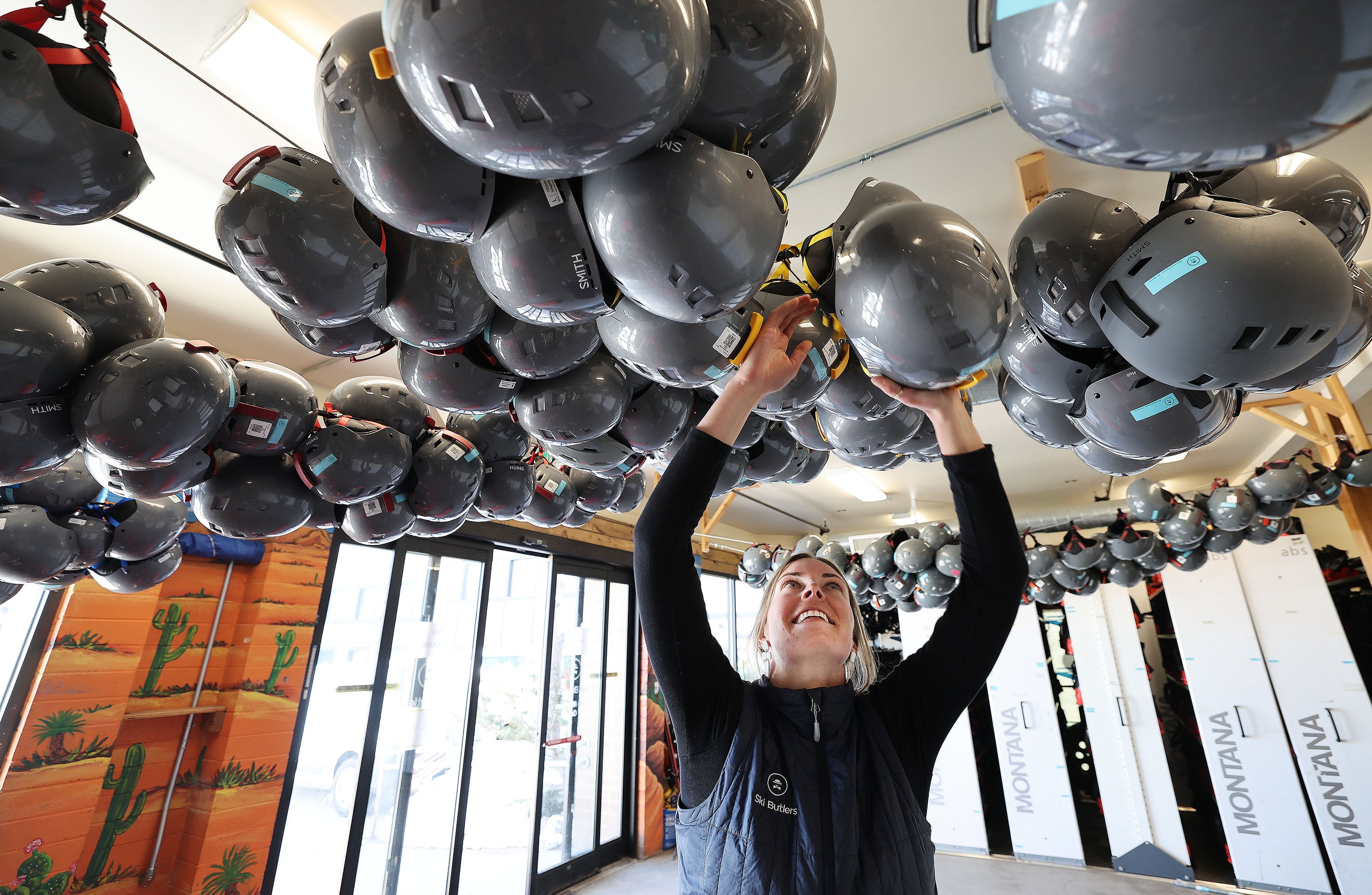 Ski Butlers general manager Sarah Shelton adjusts hanging ski helmets in Park City on March 19. The ski shop was awarded most trustworthy business in Utah.