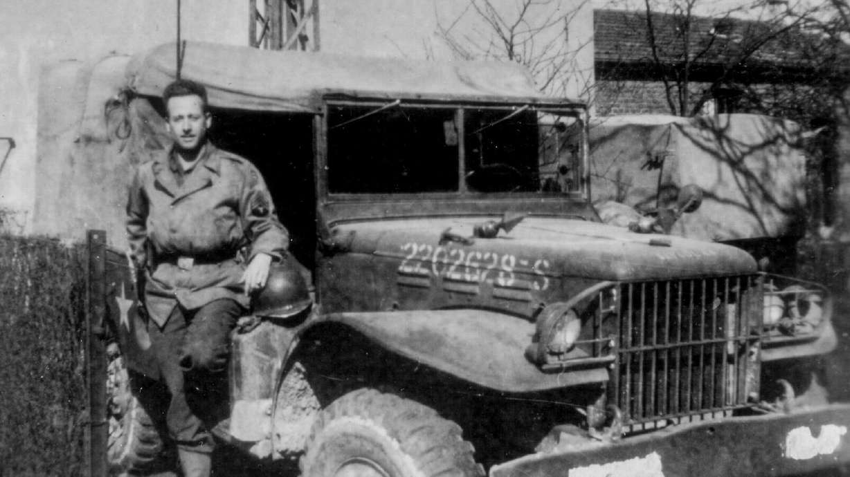 Staff Sgt. Stanley Nance, who served in the once-secret 23rd Headquarters Special Troops, a unit also known as the Ghost Army, stands alongside his radio vehicle, circa 1945.